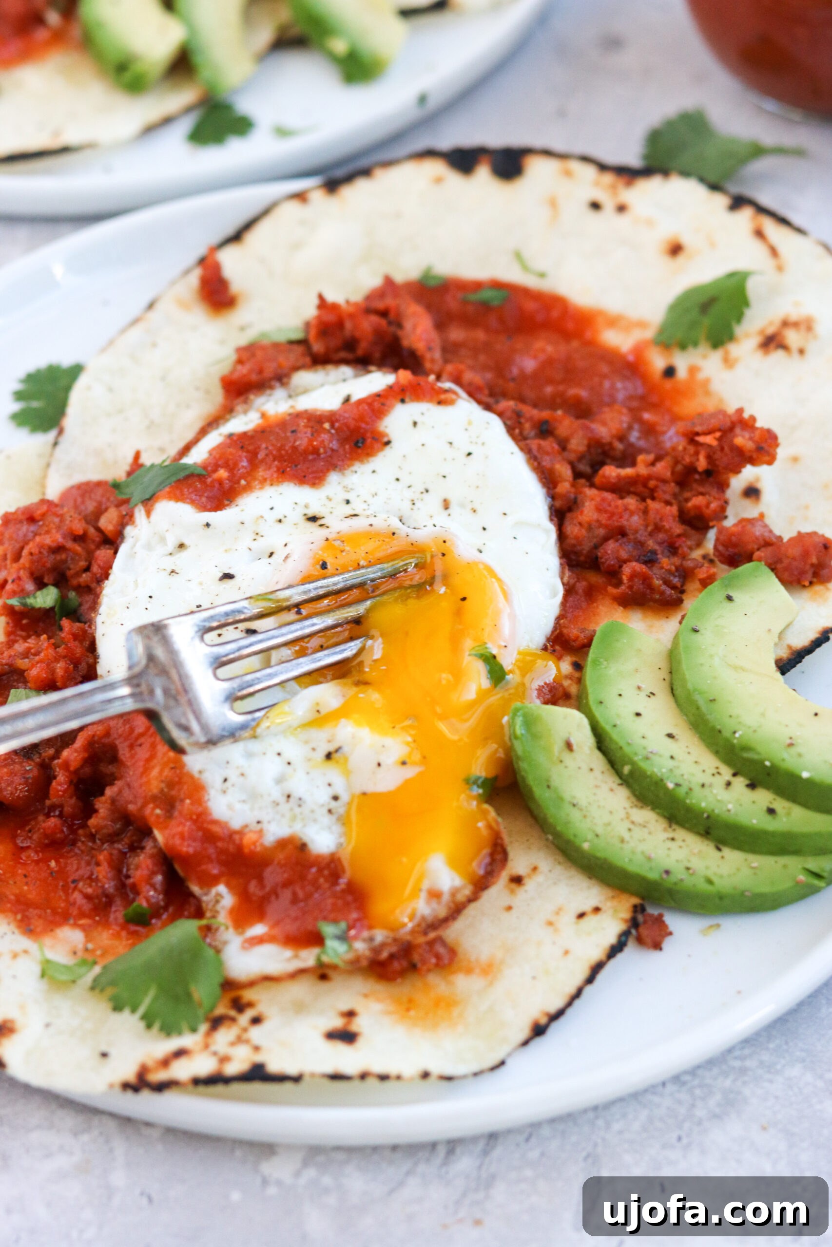 Spicy Paleo Chorizo Huevos Rancheros 6 Close-up of a runny egg yolk over Paleo Chorizo Huevos Rancheros