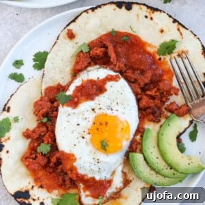 Paleo Chorizo Huevos Rancheros with a fried egg and sauce