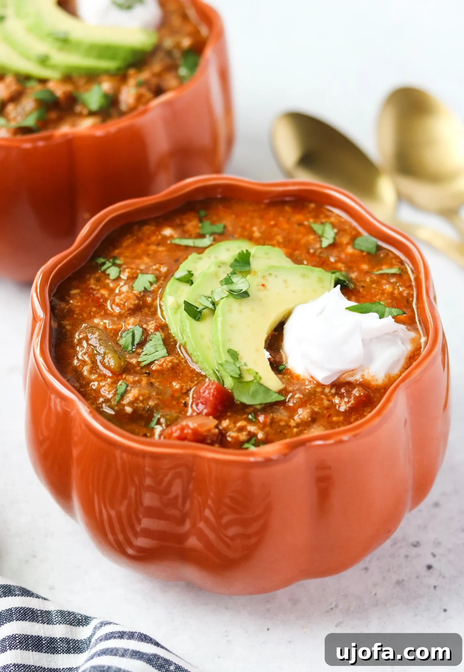 A close-up shot of the rich, thick Instant Pot Pumpkin Turkey Chili, showing tender ground turkey, diced peppers, and a sprinkle of fresh herbs.