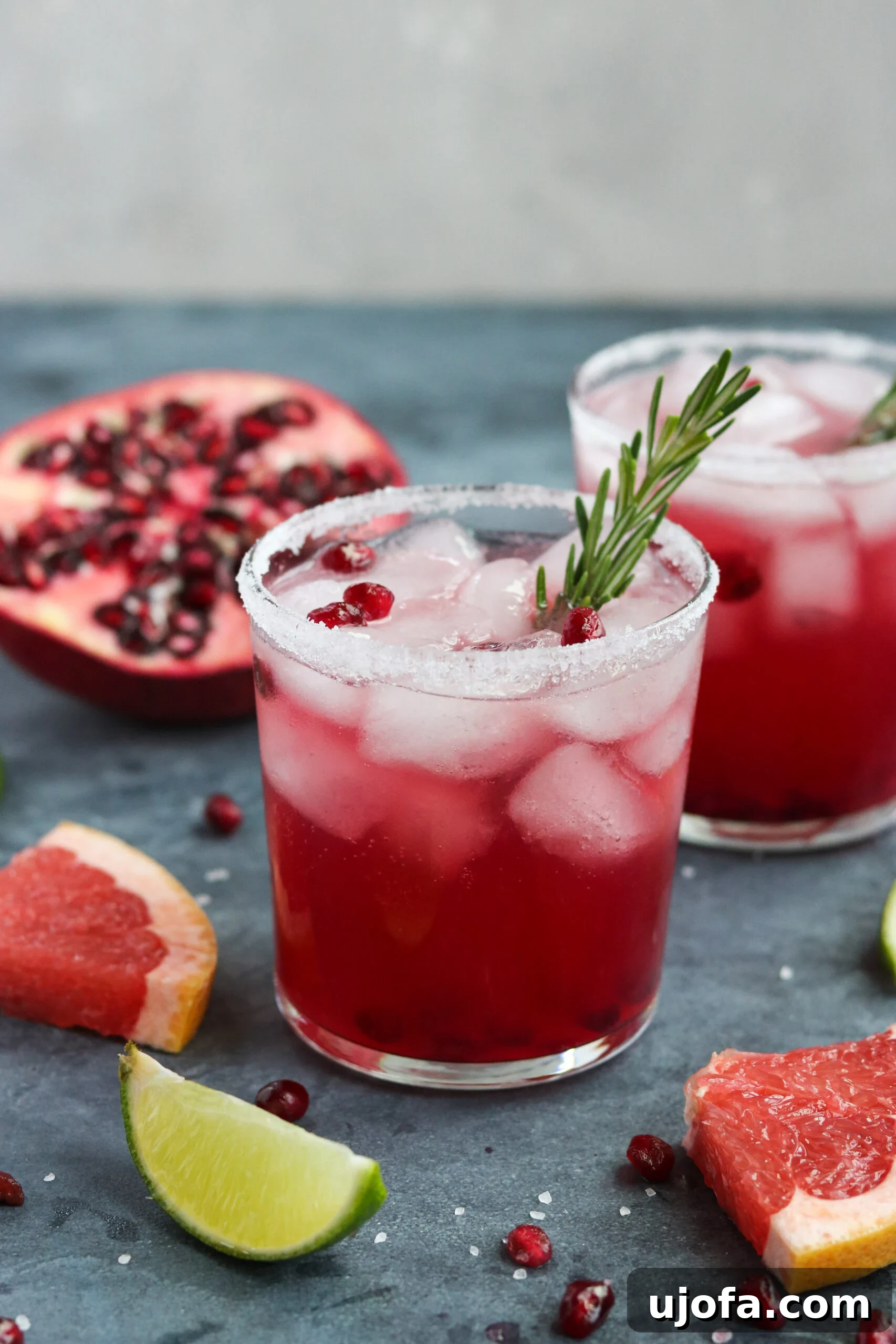 Primal Pomegranate Palomas 2 A festive grapefruit cocktail with pomegranate seeds and a rosemary sprig