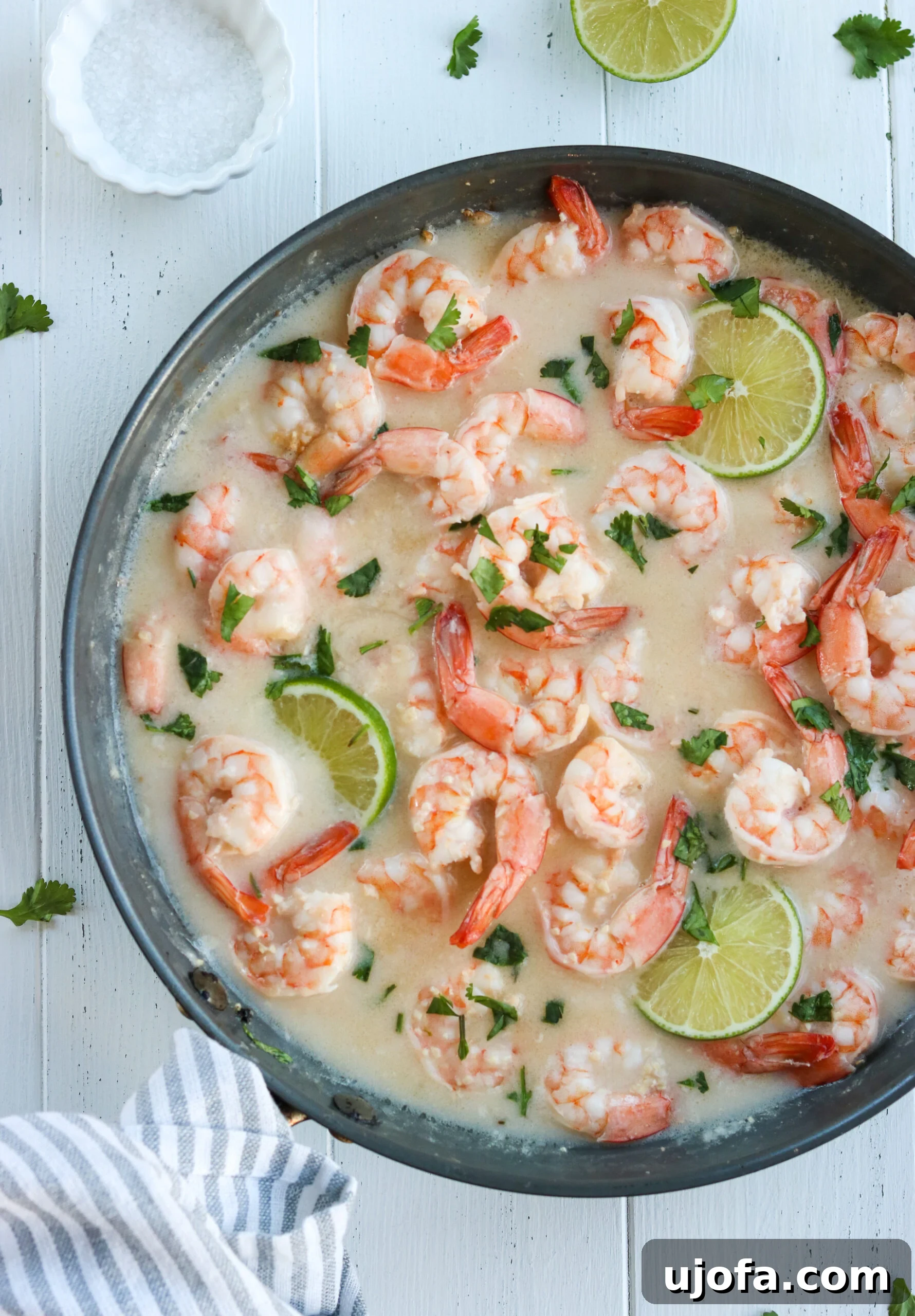 Delicious Whole30 Coconut Lime Shrimp Skillet with fresh lime and cilantro garnish