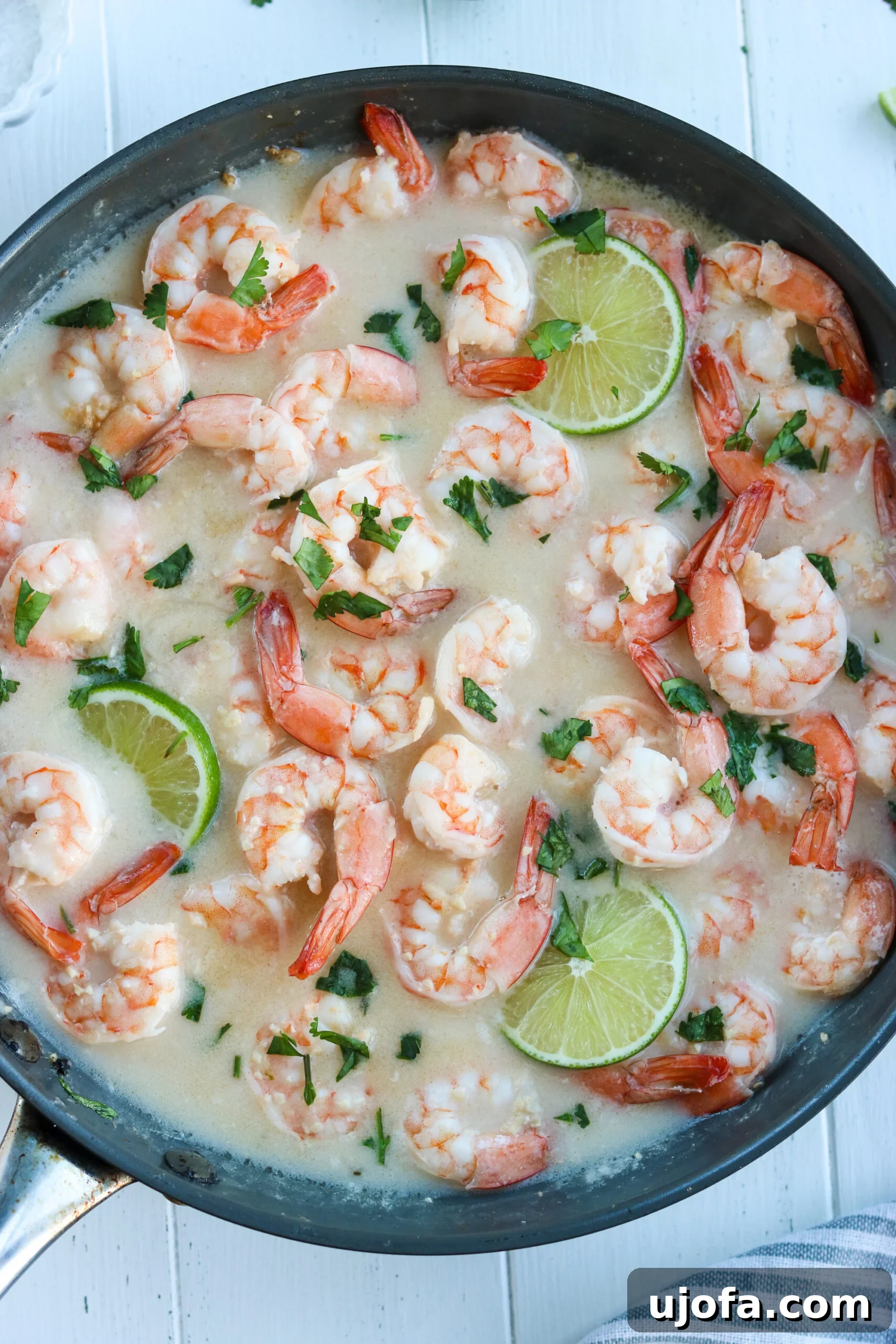 Close-up of skillet with perfectly cooked Whole30 Coconut Lime Shrimp