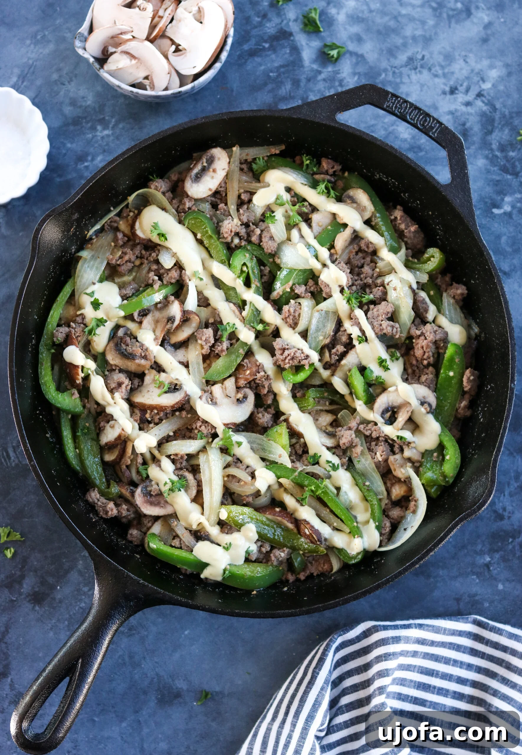 Whole30 Philly Cheesesteak Skillet with tender ground beef, sautéed onions, peppers, mushrooms, and creamy dairy-free cheese sauce.