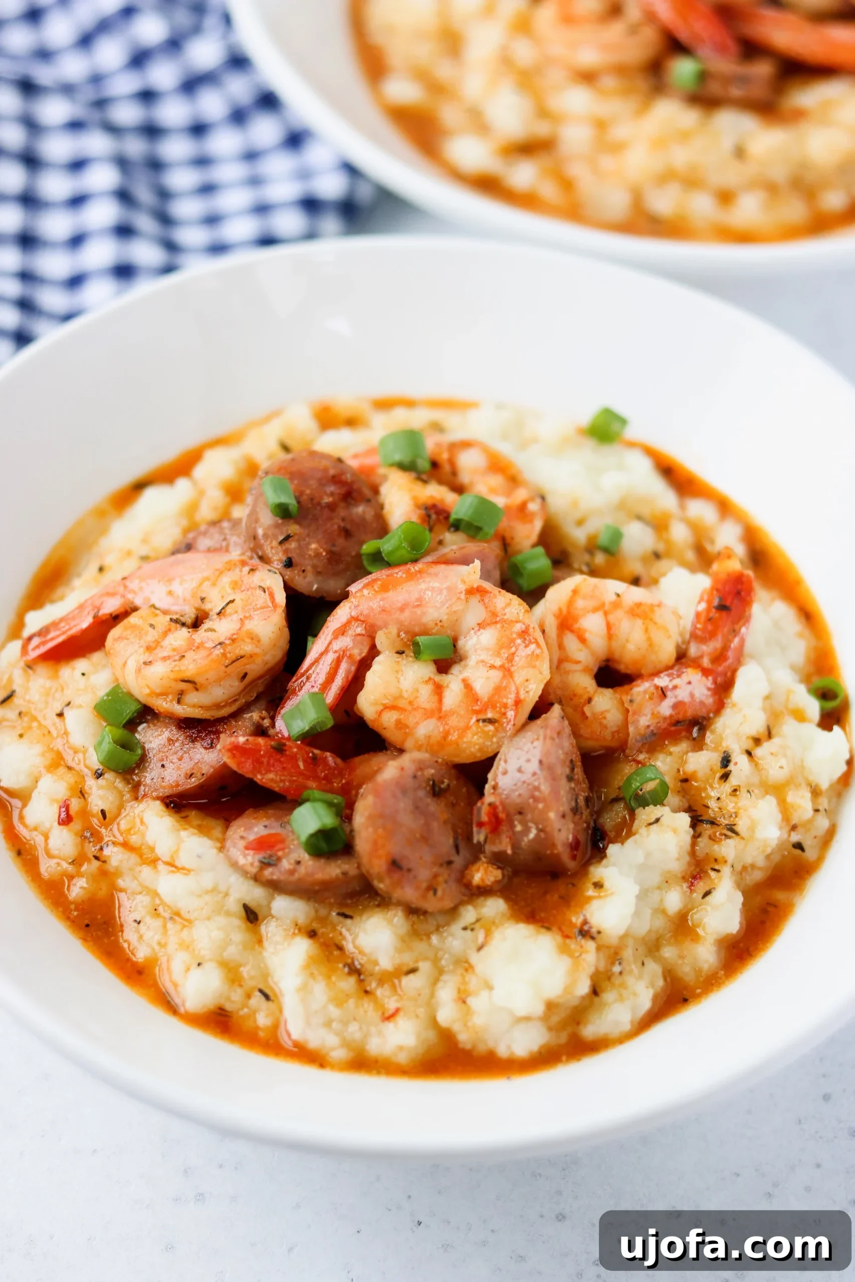 Keto and Paleo Shrimp and Sausage in a creole gravy over cauliflower mash in a white bowl