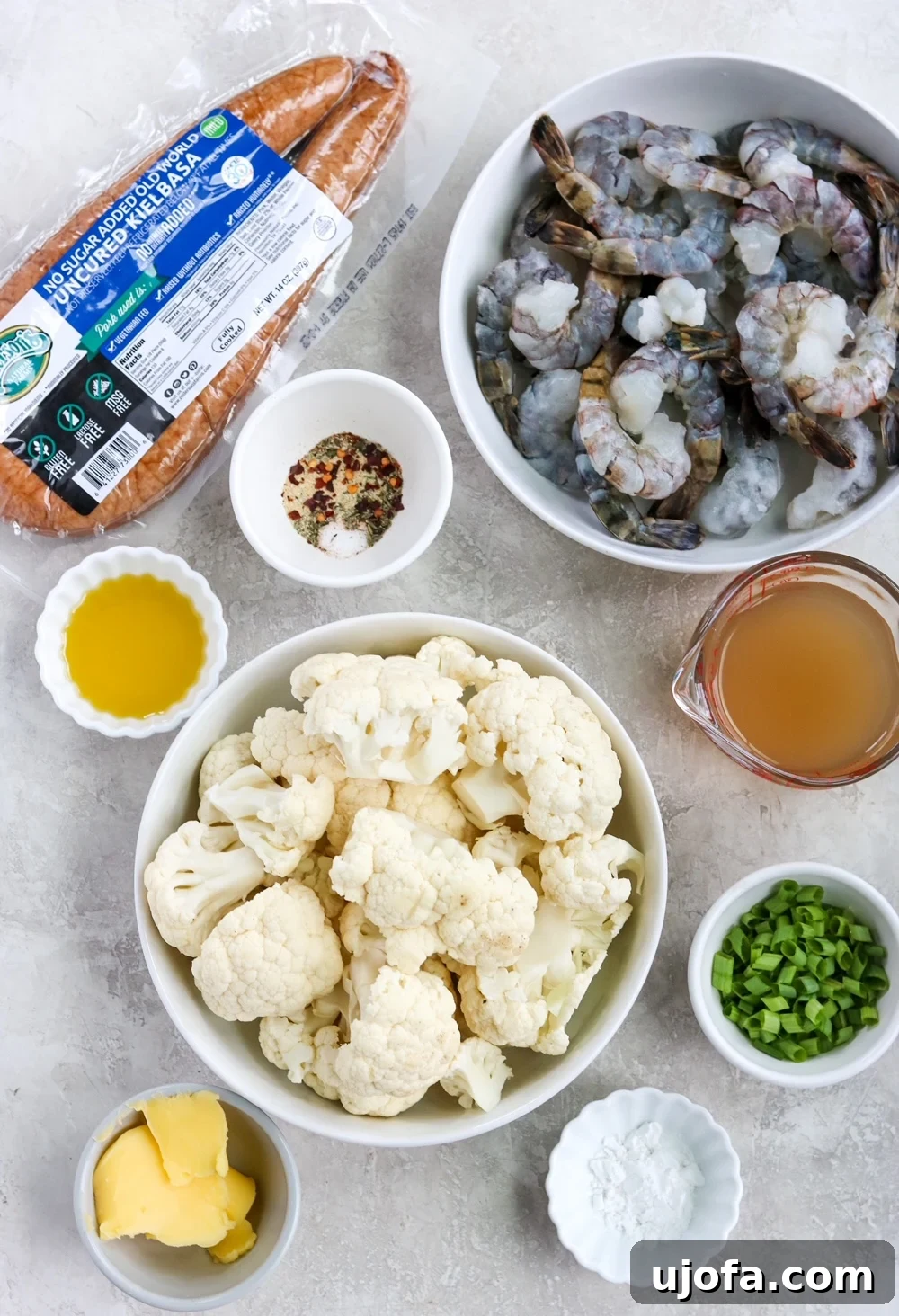 Ingredients for Keto Shrimp and Grits - raw shrimp, cauliflower florets, kielbasa, green onions, broth, spices, and ghee