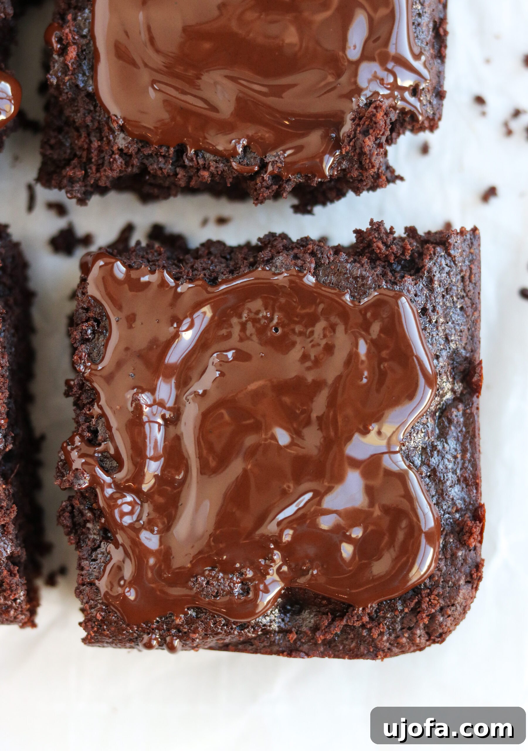 a perfectly cut slice of Paleo Double Chocolate Thin Mint Brownie, revealing its moist crumb and rich chocolate layers