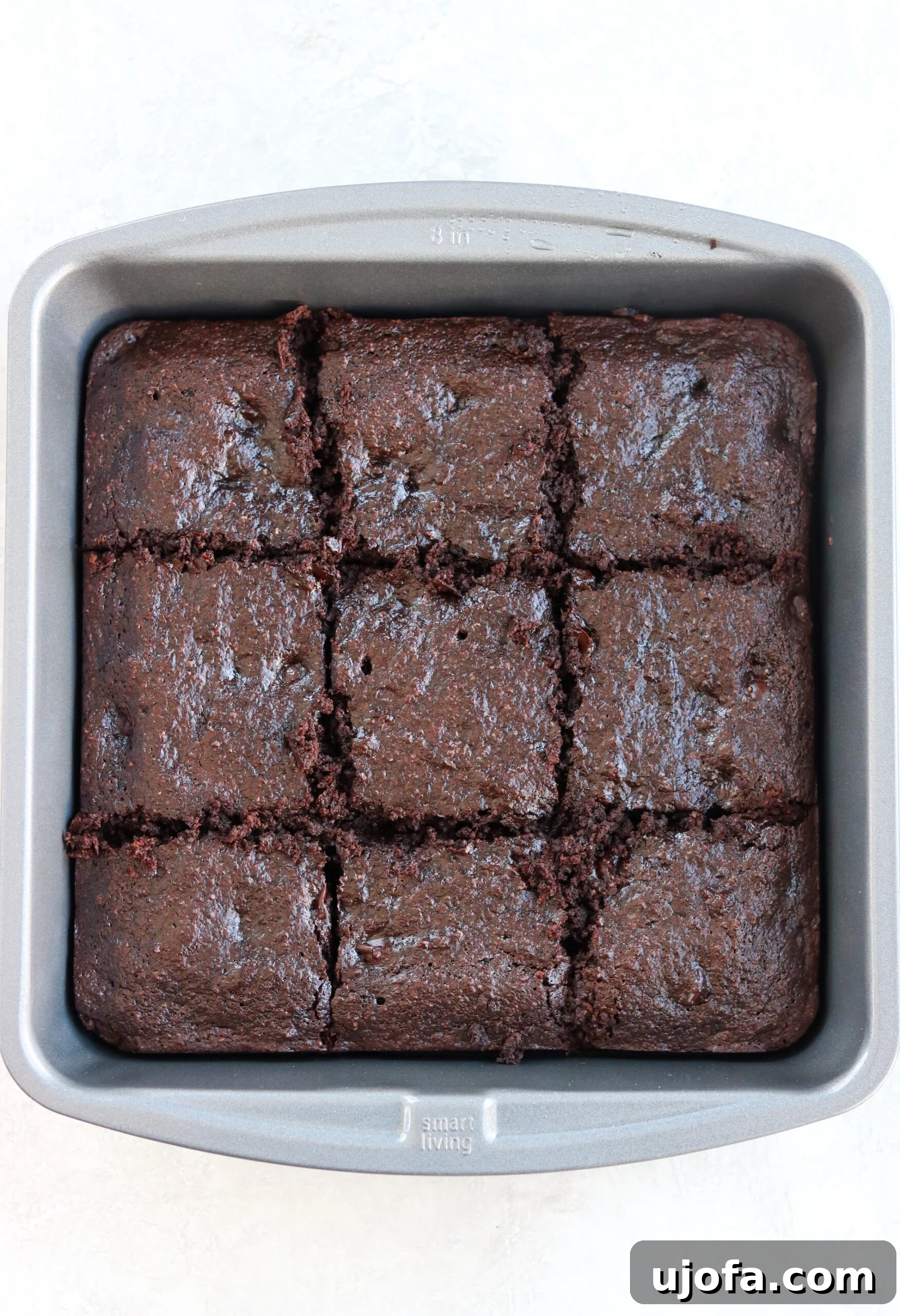 a baking pan filled with freshly baked, uncut chocolate brownies