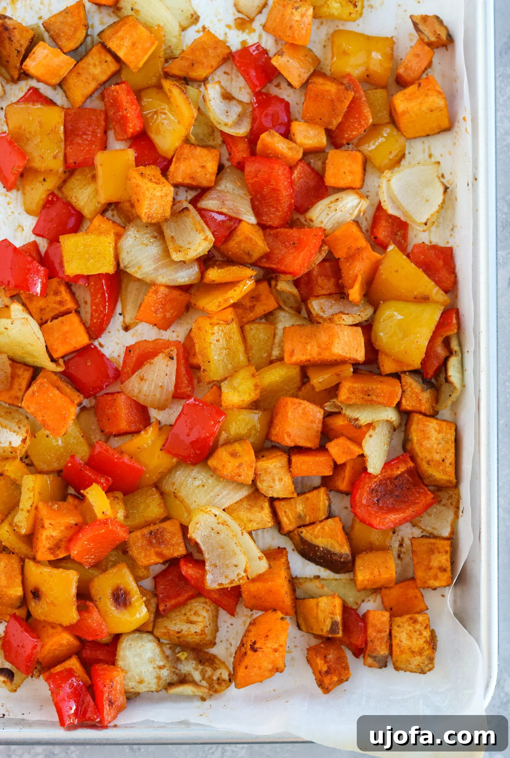 Perfectly Roasted Mexican Vegetables for Burrito Bowls Mexican roasted vegetables with colorful bell peppers, red onions, and sweet potatoes seasoned with spices