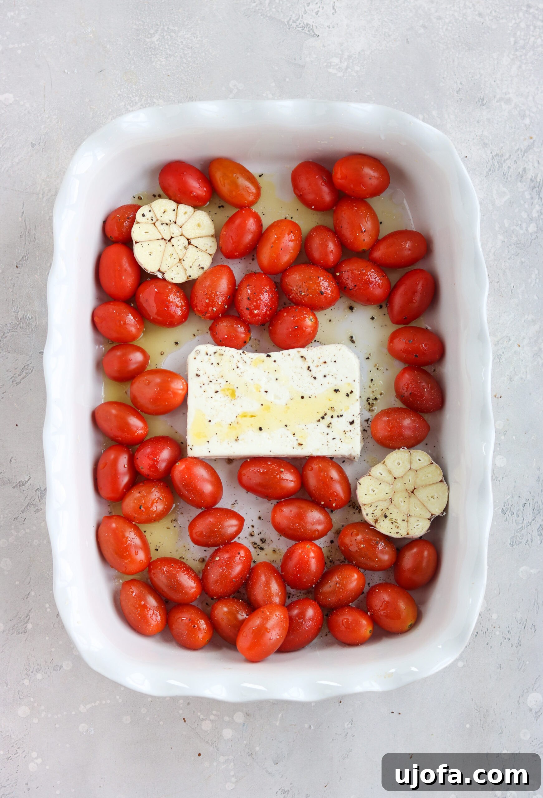 Cherry tomatoes and feta in a baking dish