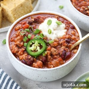 Classic Slow Cooker Turkey Chili with sour cream and jalapeño slices, ready for serving.