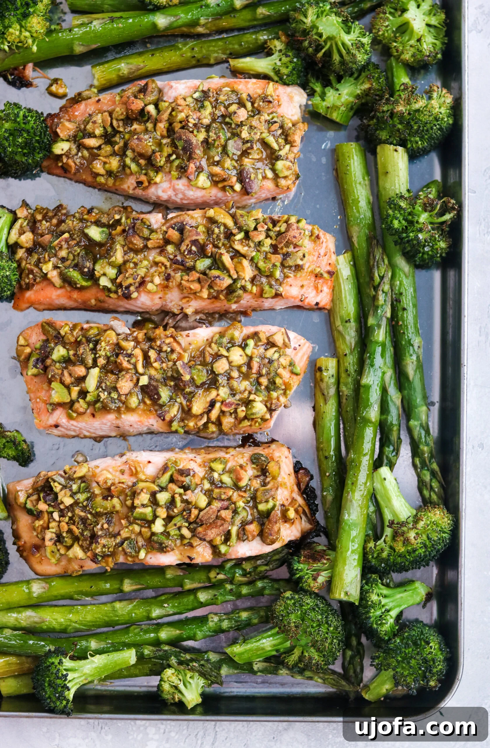 Crusted Salmon with Spring Veggies on a baking sheet