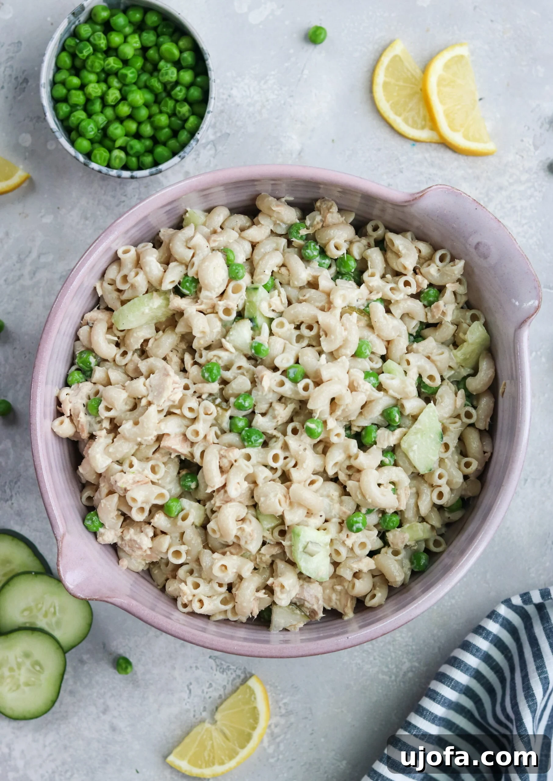 Tuna Macaroni Salad with Fresh Ingredients Close-up of creamy tuna macaroni salad featuring peas, tuna, and fresh cucumber