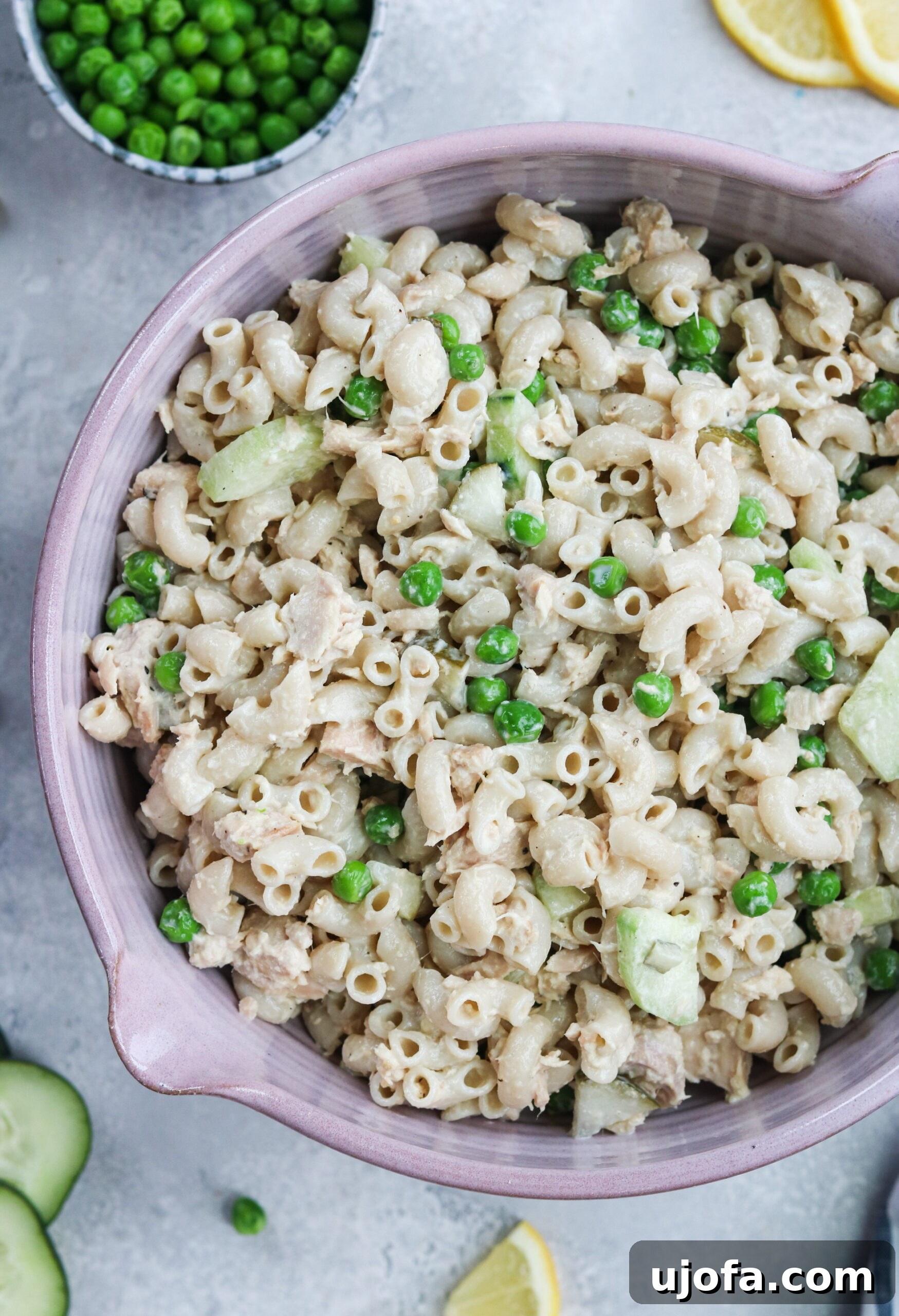 Tuna Macaroni Salad Ready to Serve Delicious Gluten-Free Tuna Macaroni Salad served in a white bowl with fresh ingredients visible on the side