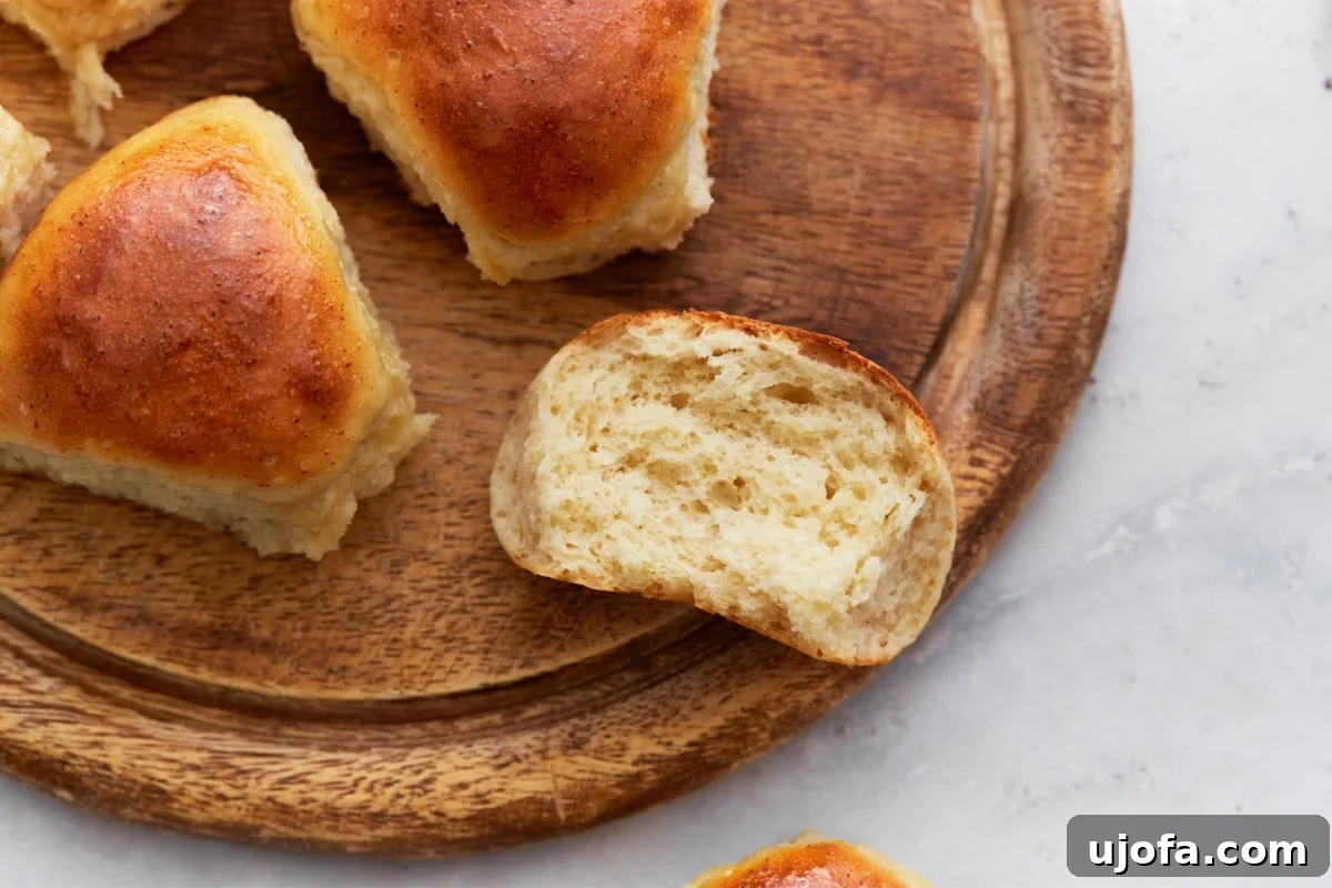 A close-up of a basket of golden-brown gluten-free dinner rolls, ready to serve