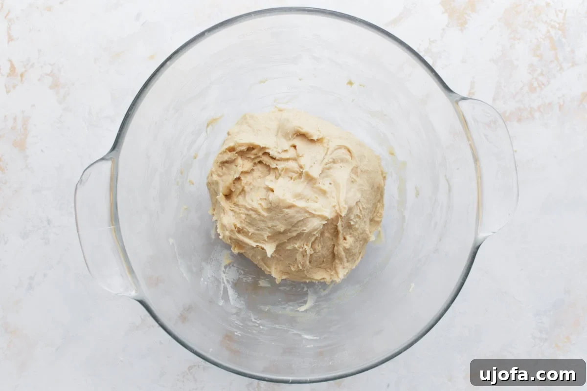 Gluten-free dough being mixed in a stand mixer with a dough hook