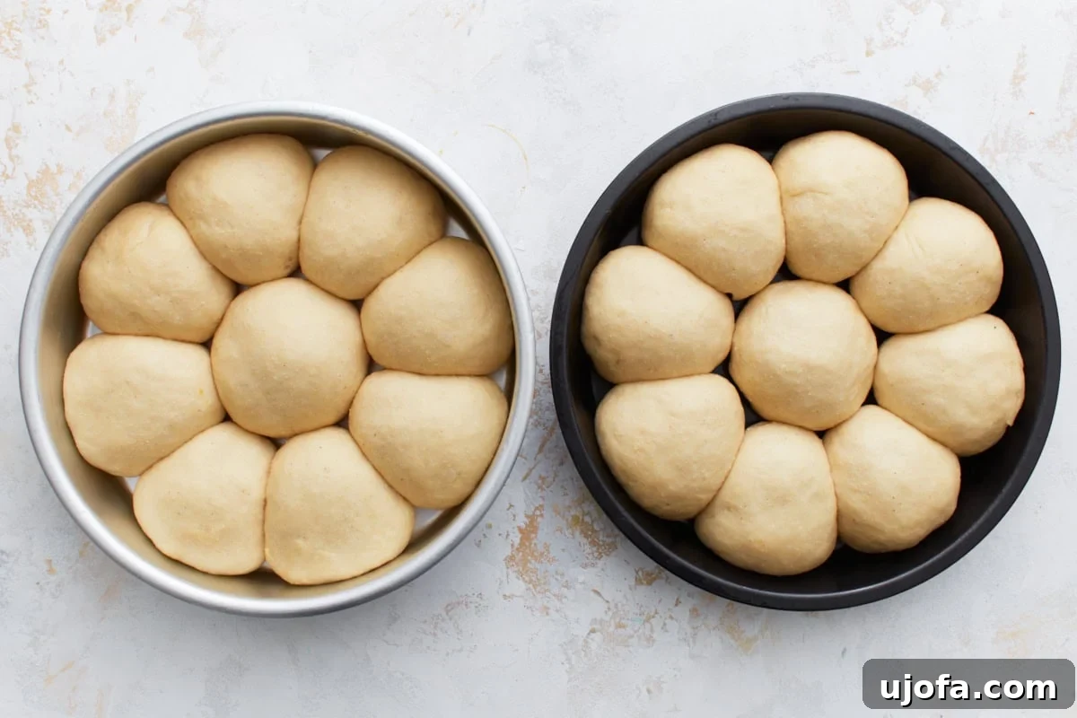 Gluten-free dinner rolls covered with a towel, rising in a warm place