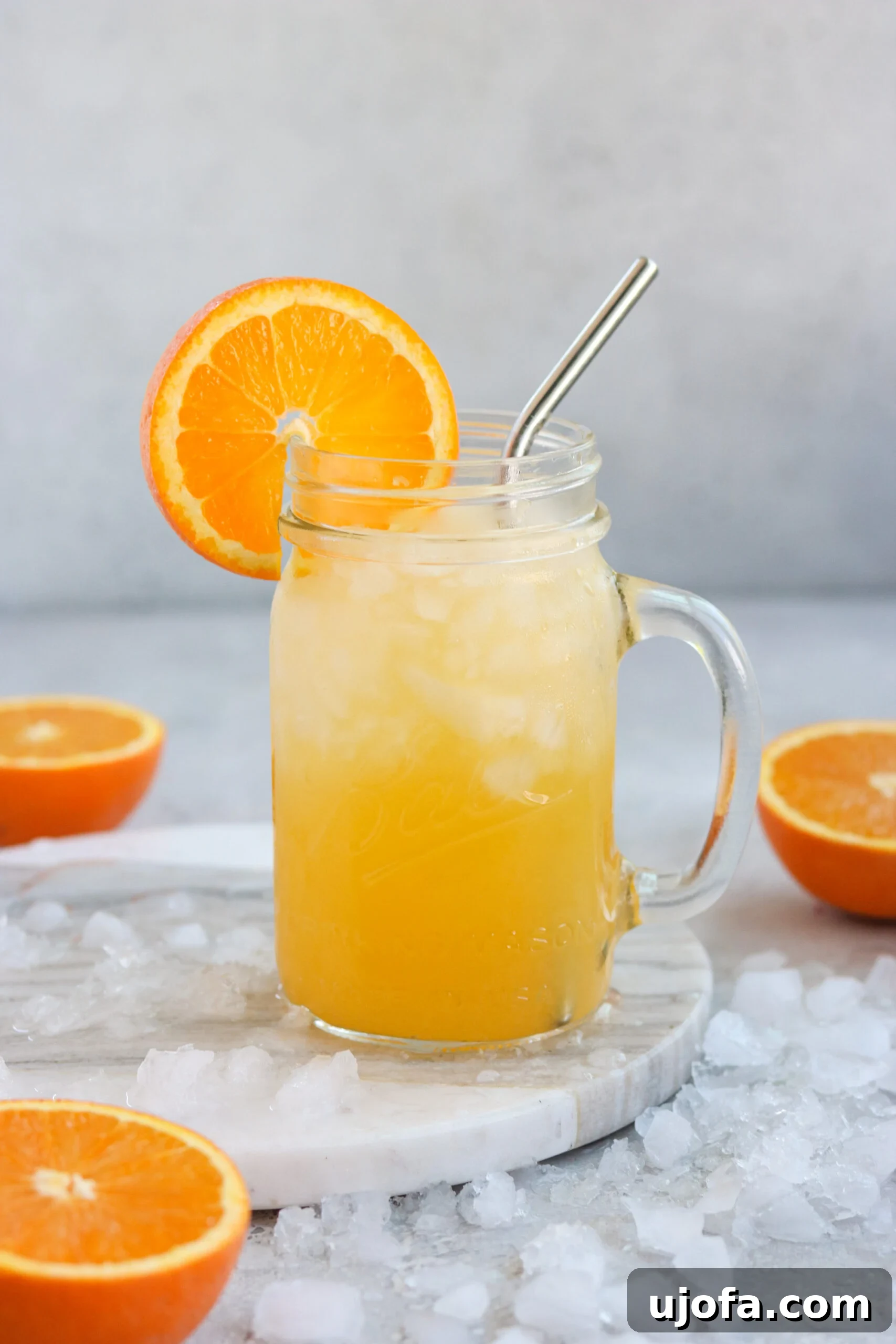 Gluten Free Orange Crush on a mason jar with steel straw