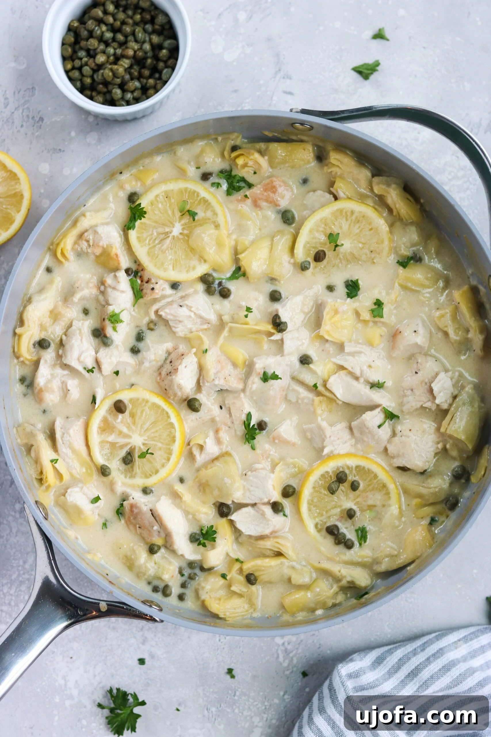 Paleo Lemon Artichoke Chicken in a Skillet, ready to serve