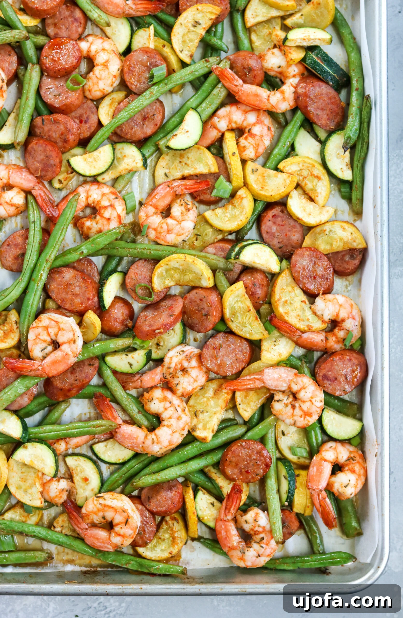 top view of Cajun Shrimp Sausage Sheet Pan with perfectly cooked shrimp, sausage, and bright green vegetables
