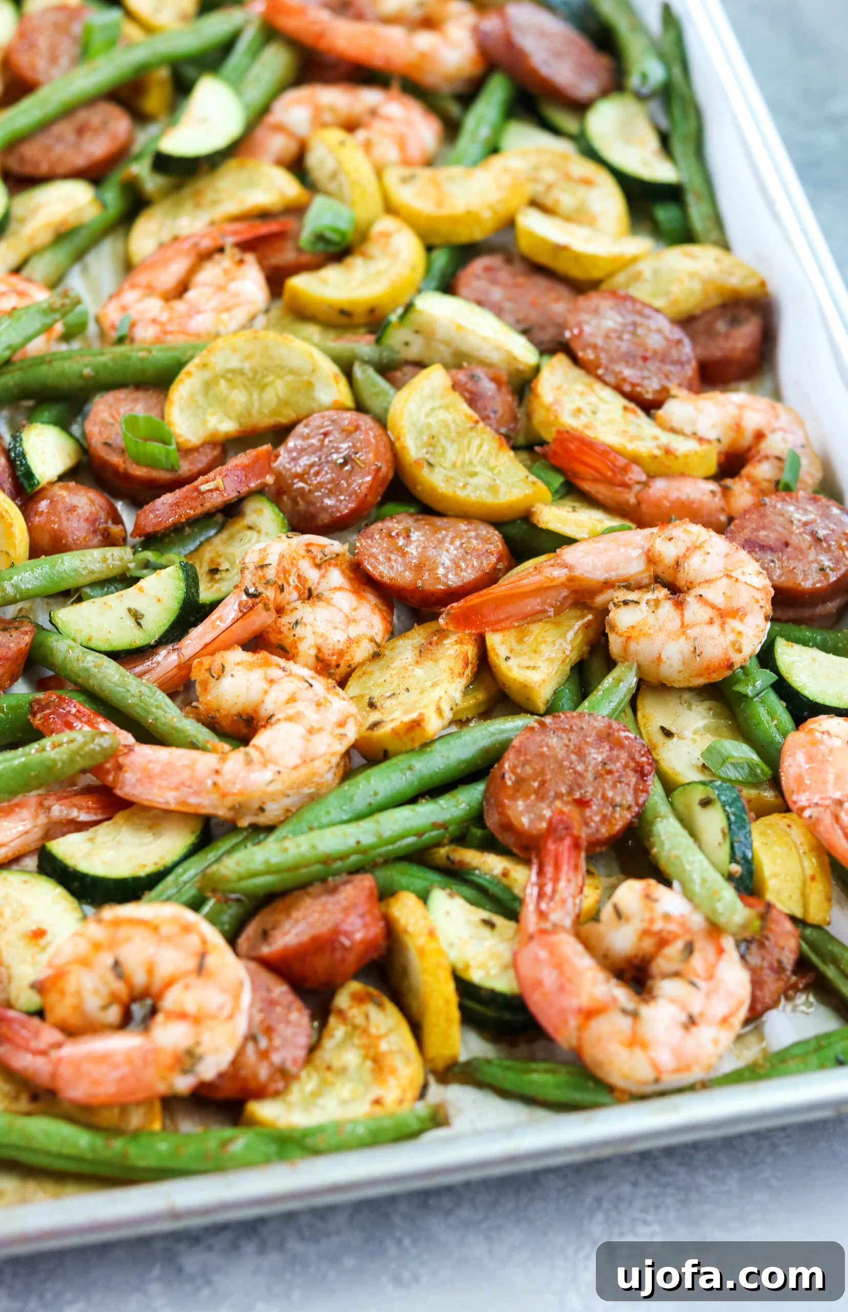 top view of seafood and vibrant vegetables ready for baking in a pan