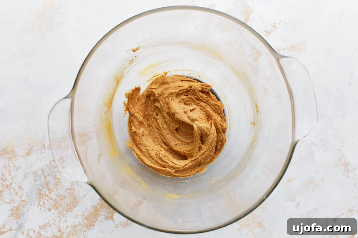 Gluten-free peanut butter blossom dough in a glass mixing bowl