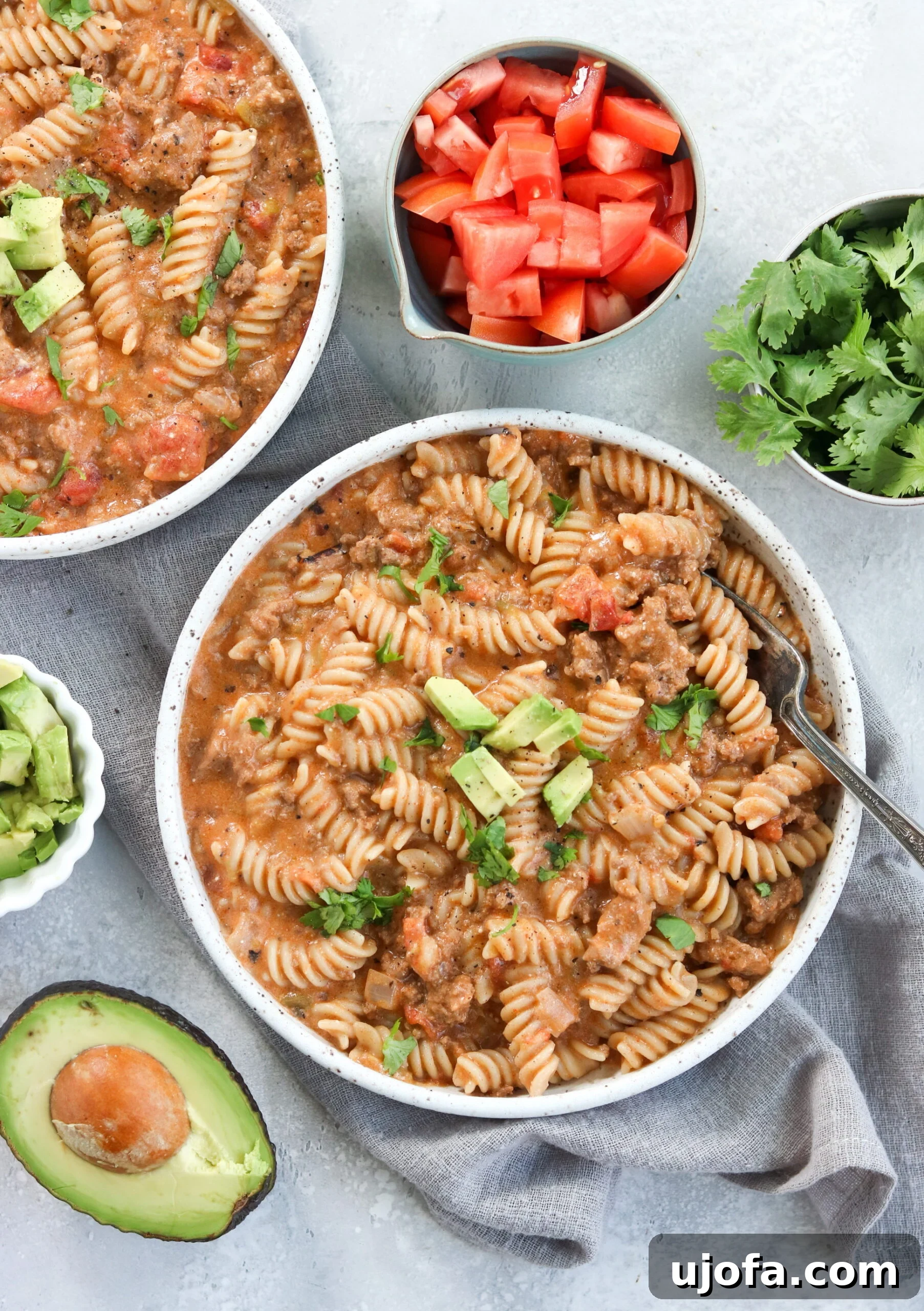 Top view of a vibrant Instant Pot Taco Pasta dish, garnished with fresh cilantro and diced tomatoes
