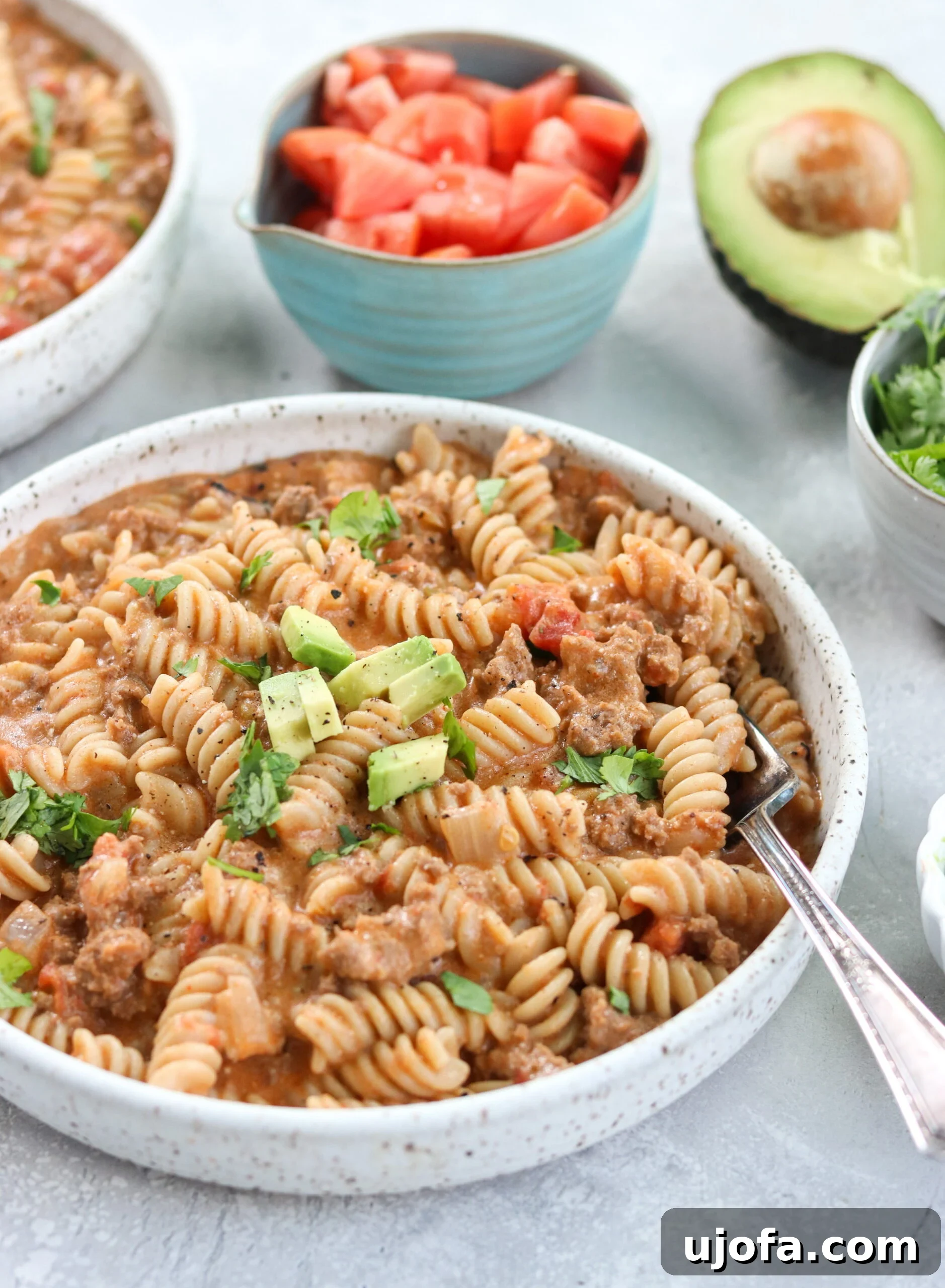 Close-up of Instant Pot Taco Pasta served in a white bowl with a fork, ready to eat