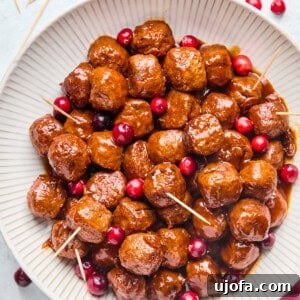 cranberry jalapeno meatballs with toothpicks in a white bowl