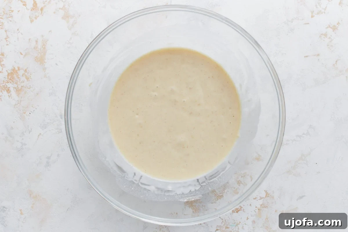 Foolproof Gluten-Free Pancakes 7 A glass mixing bowl with smooth, fully mixed gluten-free pancake batter, ready to be poured onto a pan.