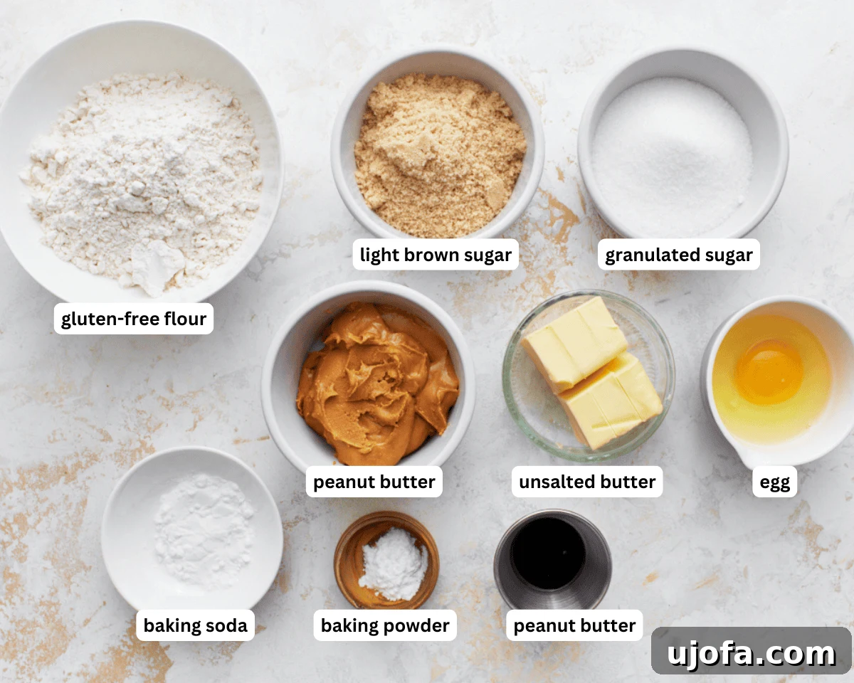 All the necessary ingredients for baking gluten-free peanut butter cookies laid out on a clean surface.