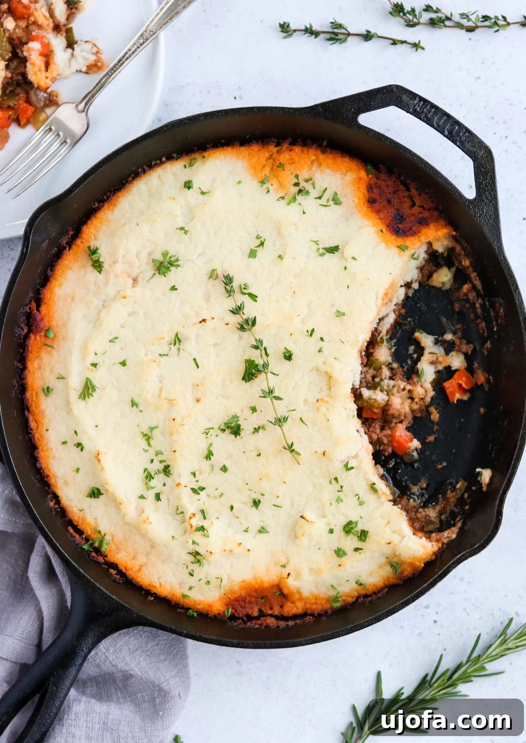 Close-up of Skillet Shepherd's Pie filling with ground beef, carrots, and peas