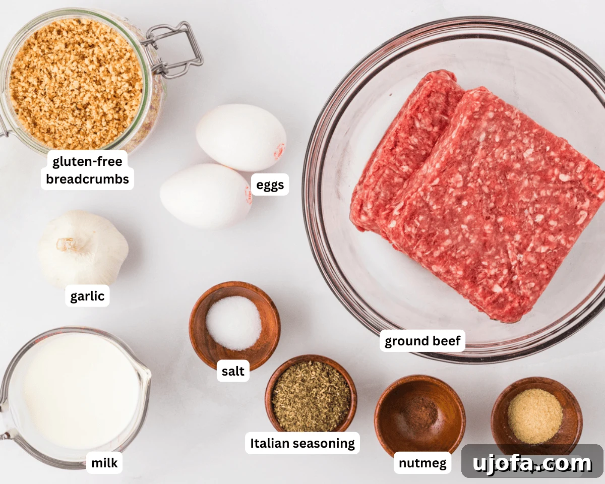 Gluten-free meatball ingredients laid out on a white surface, including ground beef, eggs, breadcrumbs, spices, and milk.