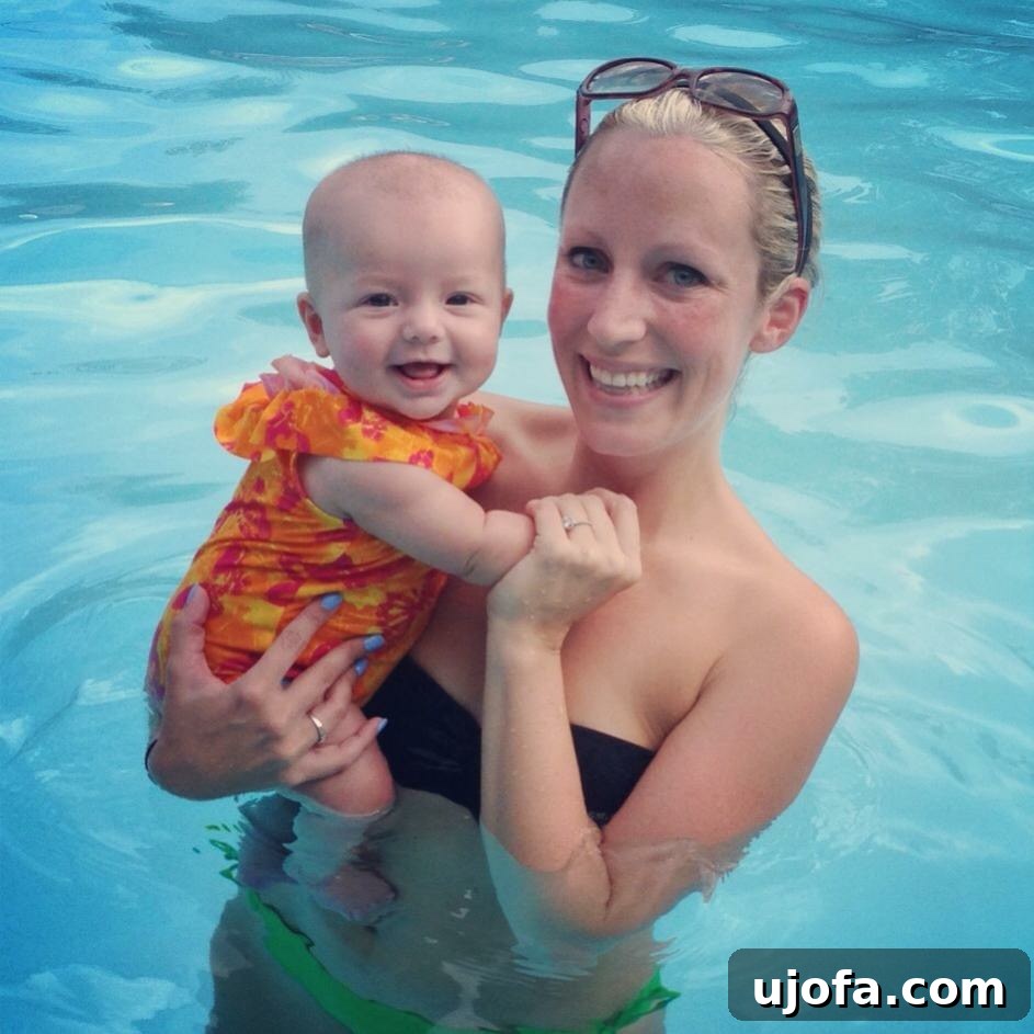 Thriving Beyond Postpartum Anxiety 2 Smiling mother holding her baby, looking happy outwardly but struggling internally with postpartum anxiety.