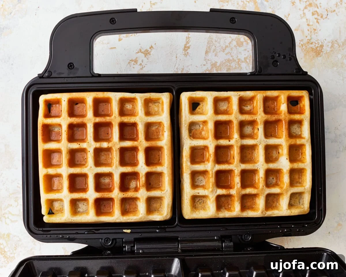 cooked gluten-free waffles in a waffle iron.