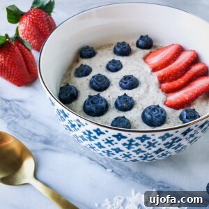 Macadamia Morning Delight 4 A bowl of creamy Macadamia N'oatmeal garnished with fresh berries and macadamia nuts.