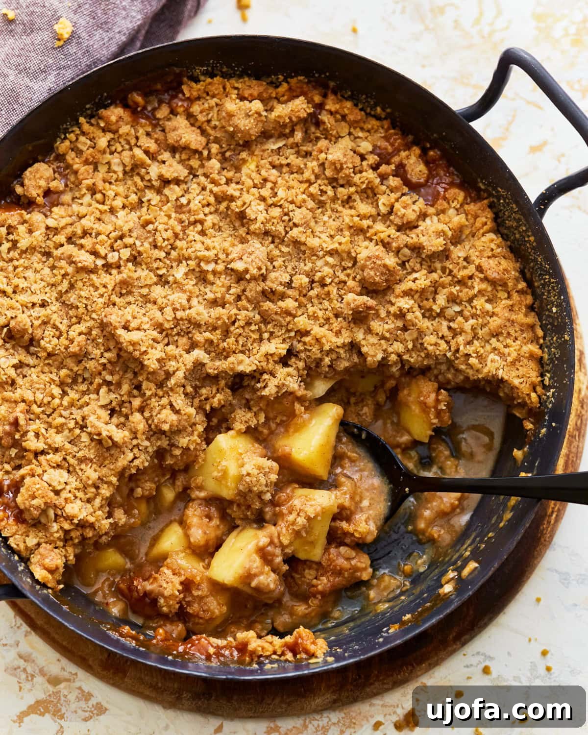 A perfectly baked gluten-free apple crisp, golden brown and bubbly, fresh from the oven, ready to be served.