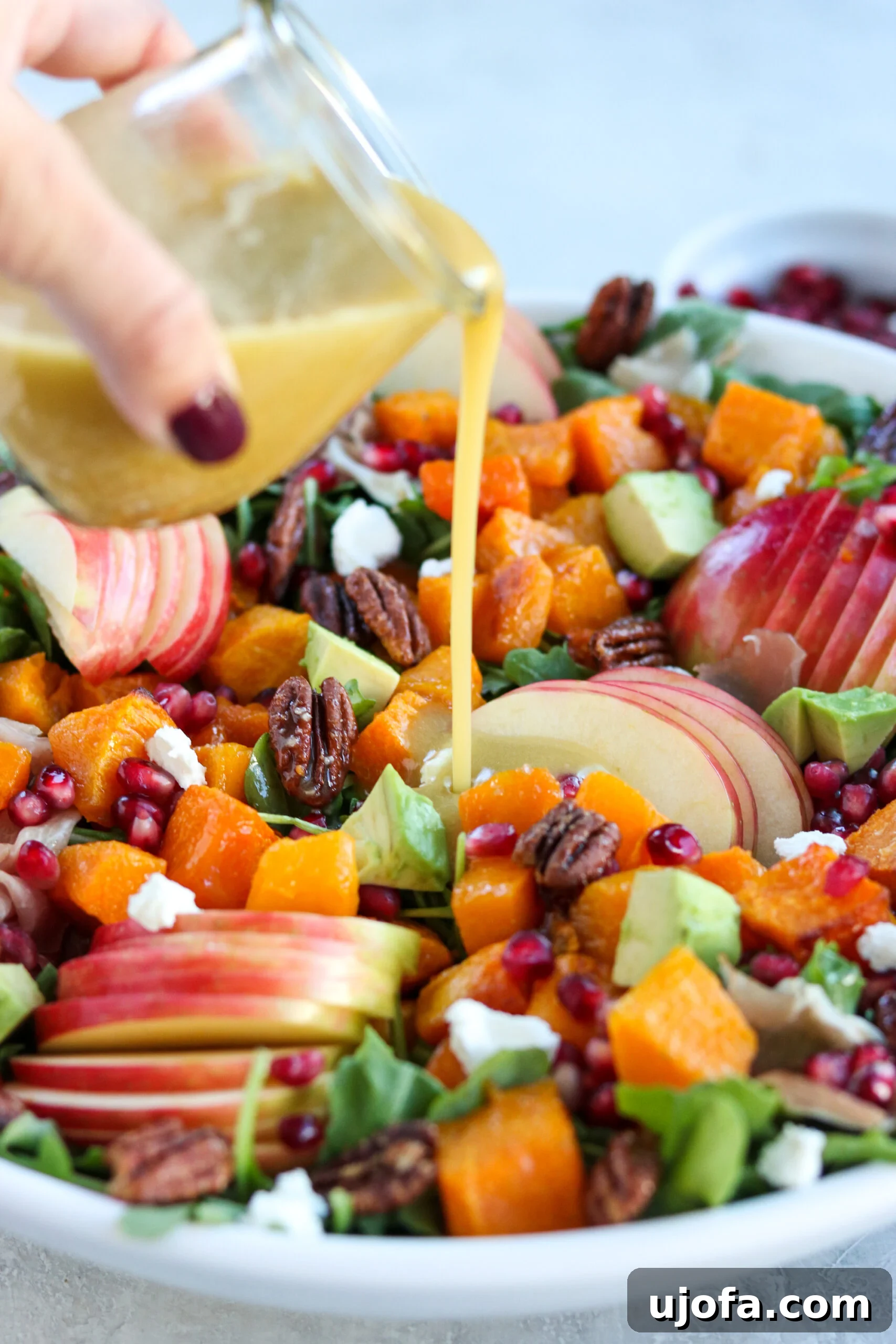 Autumn's Bounty Salad with Maple Apple Cider Vinaigrette 7 Pouring maple apple cider vinaigrette on fall harvest salad, showing the vibrant colors of the ingredients