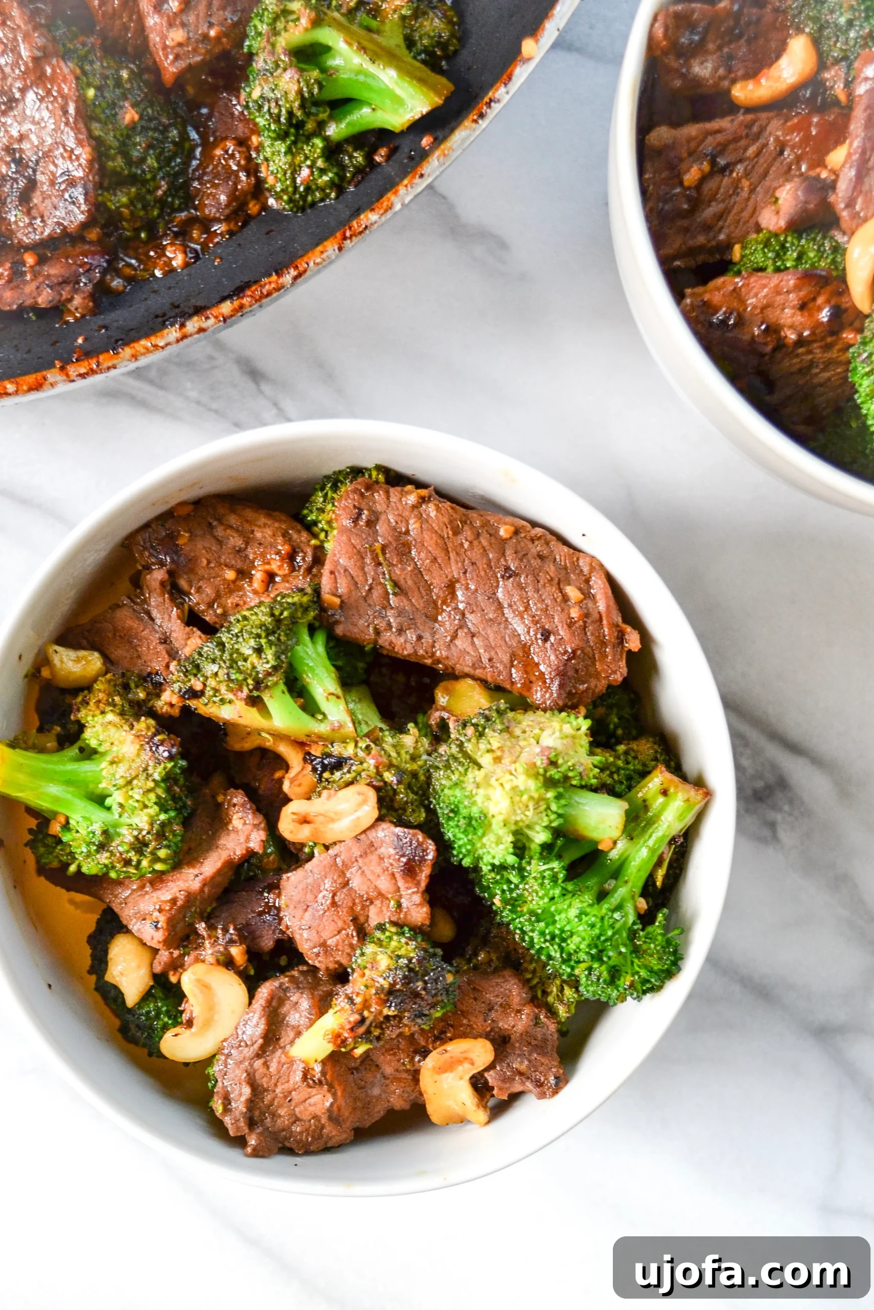 Close-up of a bowl of Whole30 Beef and Broccoli, highlighting the tender beef, bright green broccoli, and crunchy cashews.