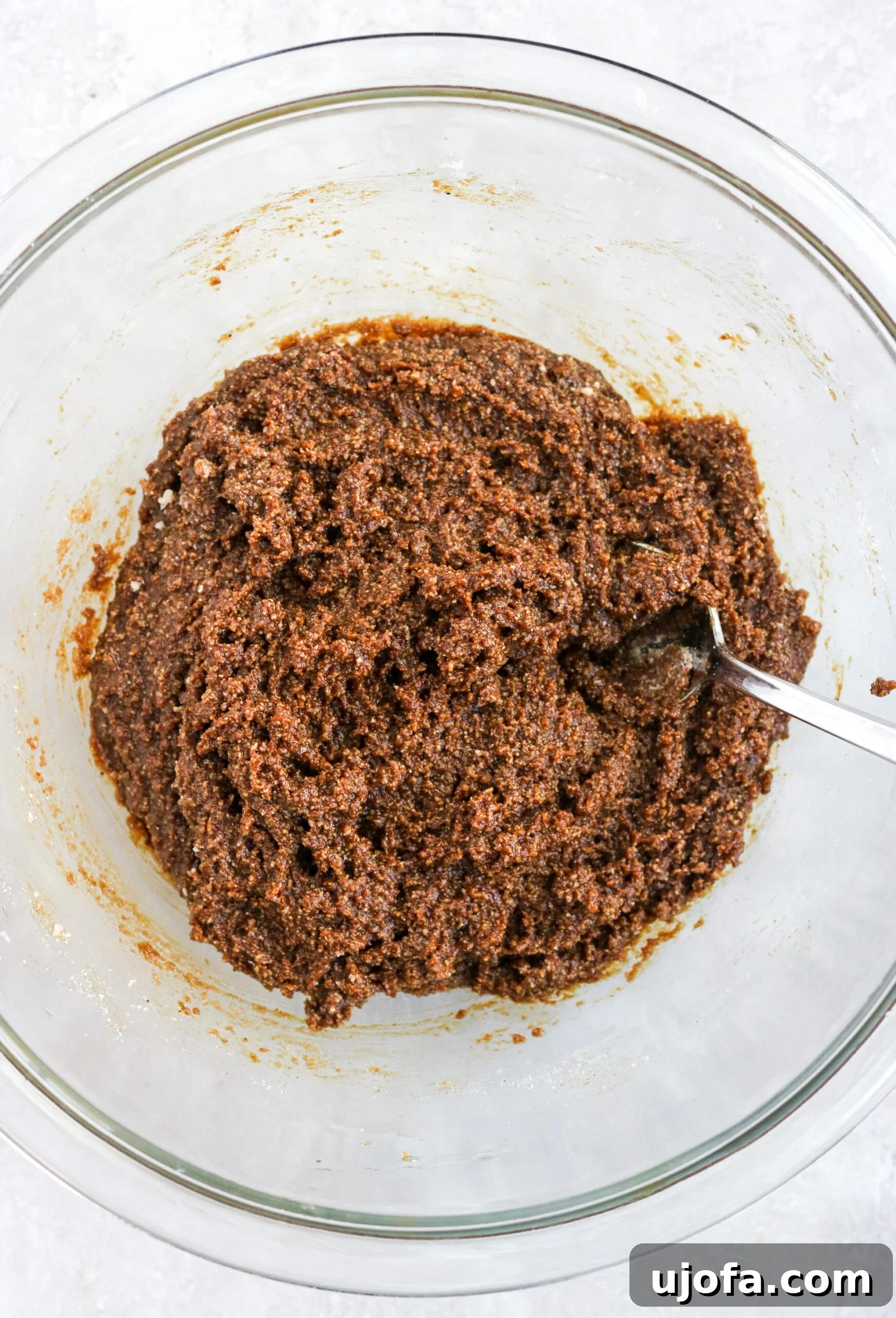 Simple Gluten Free Almond Flour Gingersnaps 4 Gluten-free gingersnap cookie batter in a clear mixing bowl with a spoon