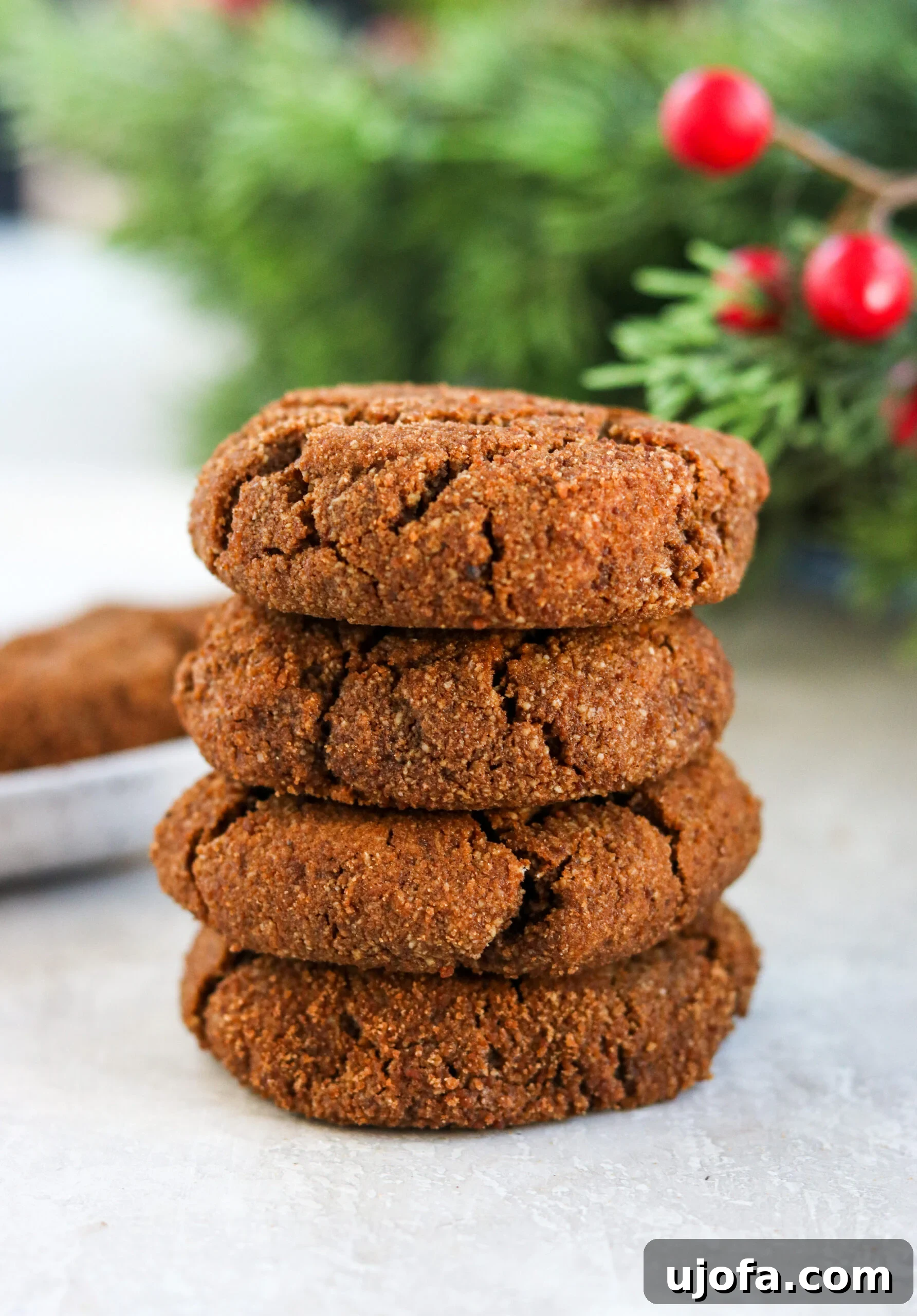 Simple Gluten Free Almond Flour Gingersnaps 5 Four gluten-free gingersnaps stacked on top of each other on a cooling rack