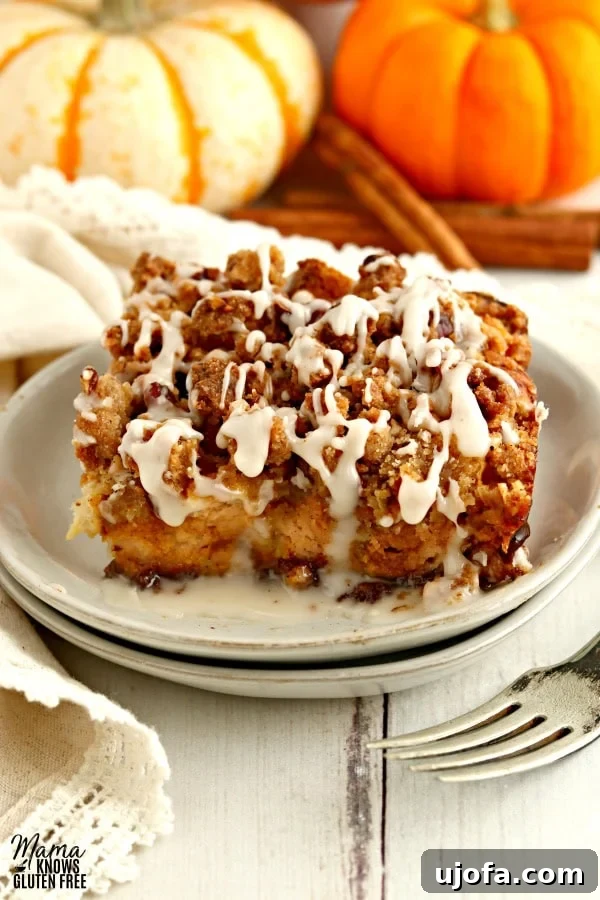 Autumn Spice Gluten-Free Pumpkin French Toast Bake 2 A beautifully plated serving of Gluten-Free Pumpkin French Toast Casserole on a white plate, ready to be enjoyed with a fork beside it.
