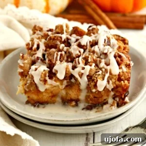 a serving of gluten-free pumpkin French toast casserole on a white plate with a fork