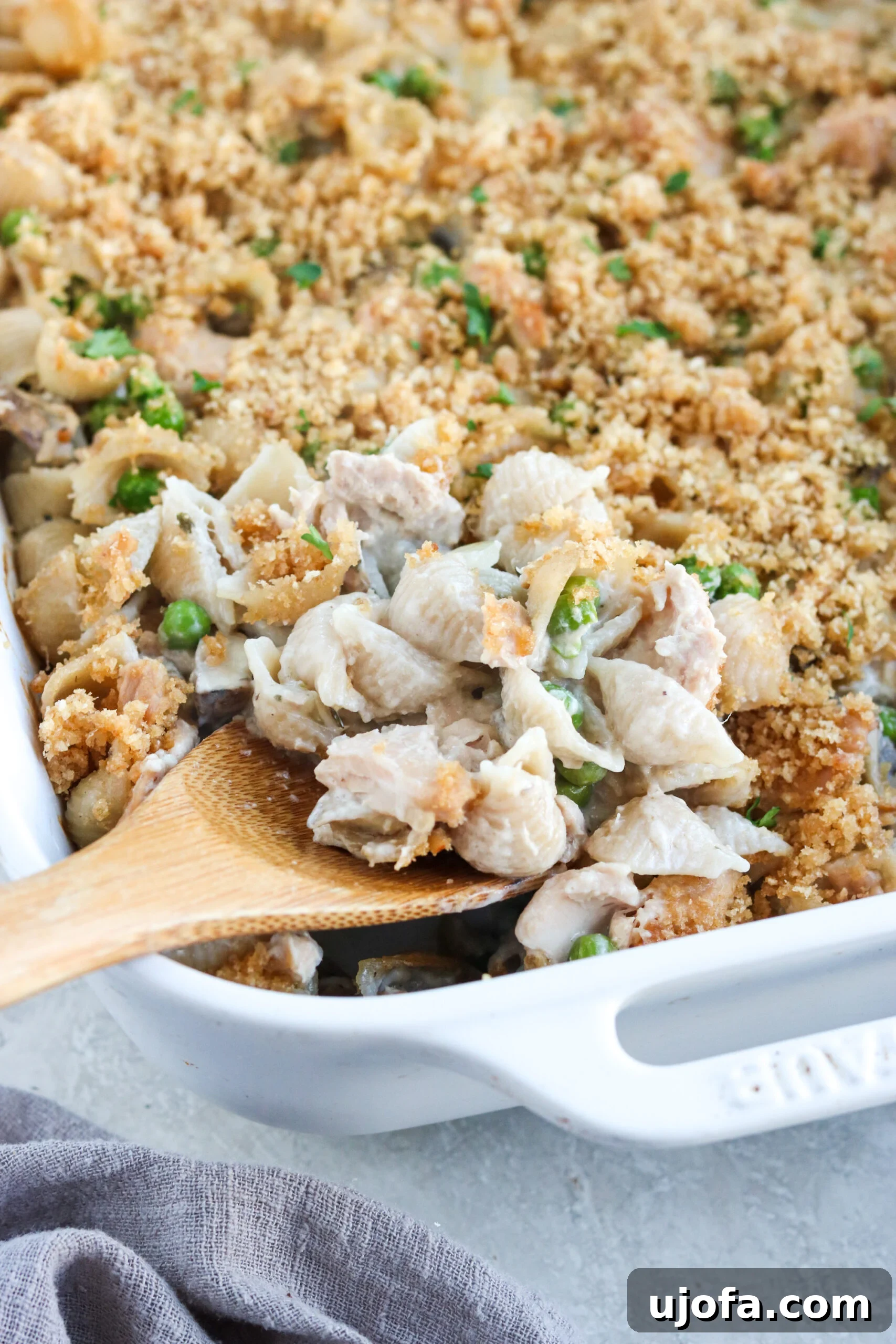 Gluten Free Tuna Casserole with peas and mushrooms in a white casserole dish