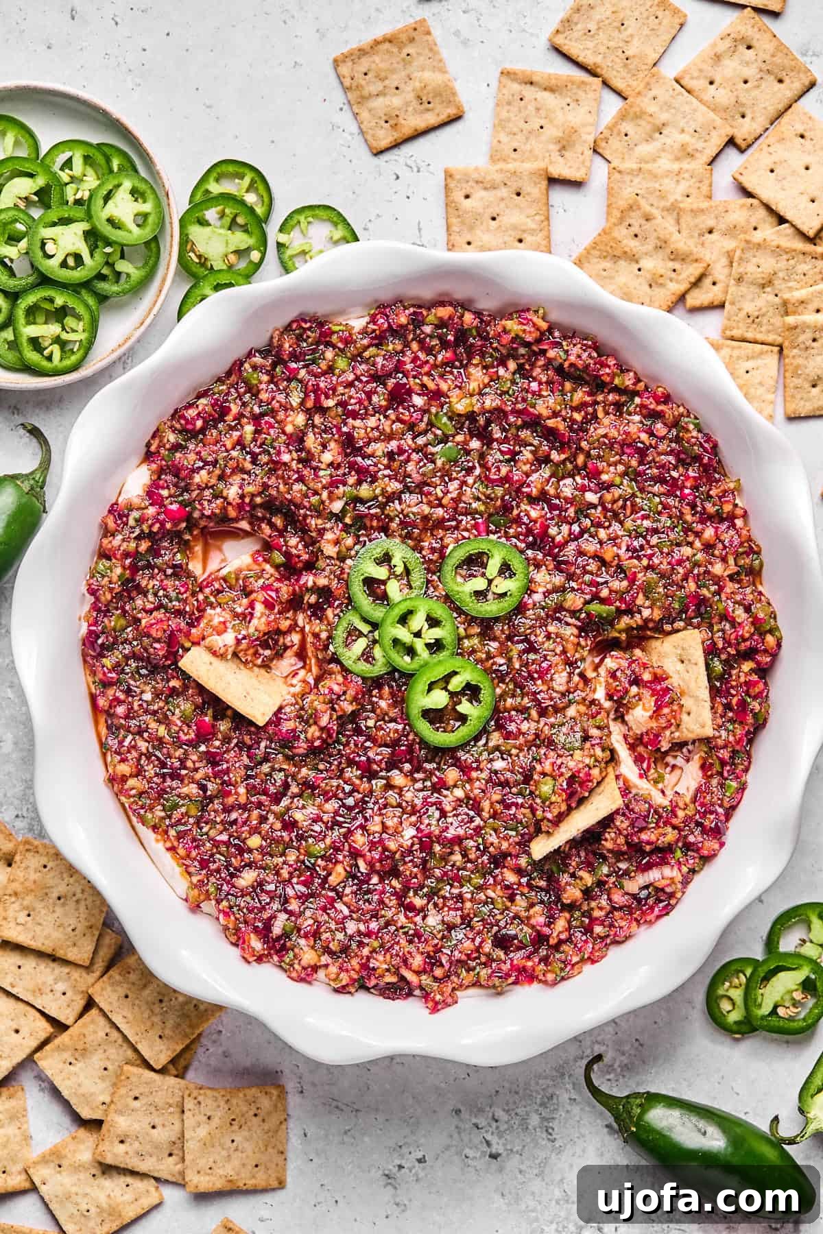 Effortless Dairy Free Cranberry Jalapeno Dip 12 cranberry jalapeno dip in a pie plate with crackers
