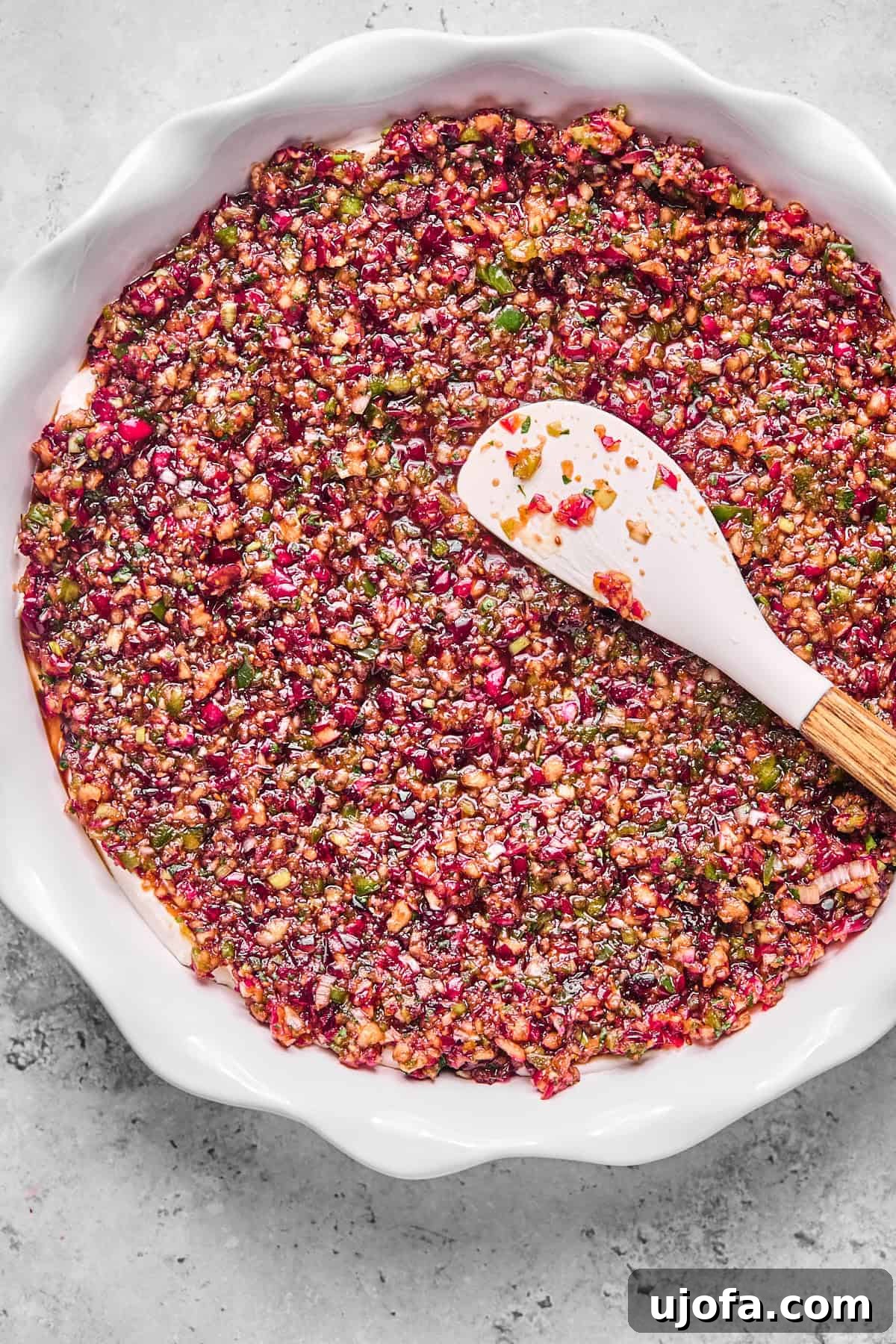 Effortless Dairy Free Cranberry Jalapeno Dip 9 cranberry jalapeno cream cheese dip in a white pie dish