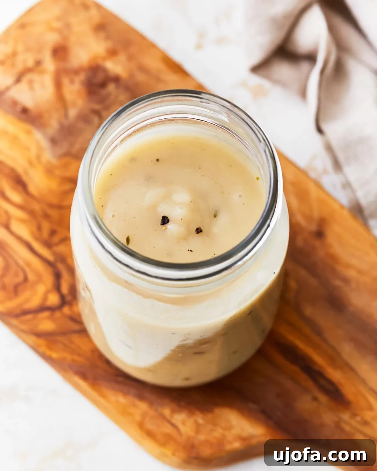 Overhead view of gluten-free gravy in a mason jar, showcasing its smooth texture.