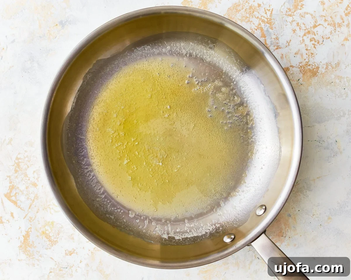 Melted butter in a small saucepan, ready for the next ingredient.
