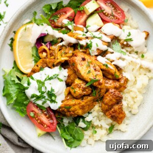 Sheet Pan Chicken Shawarma Power Bowls 11 Sheet Pan Chicken Shawarma Bowl with cauliflower rice, tomatoes, parsley, lemon, tzatziki, and lemon tahini dressing
