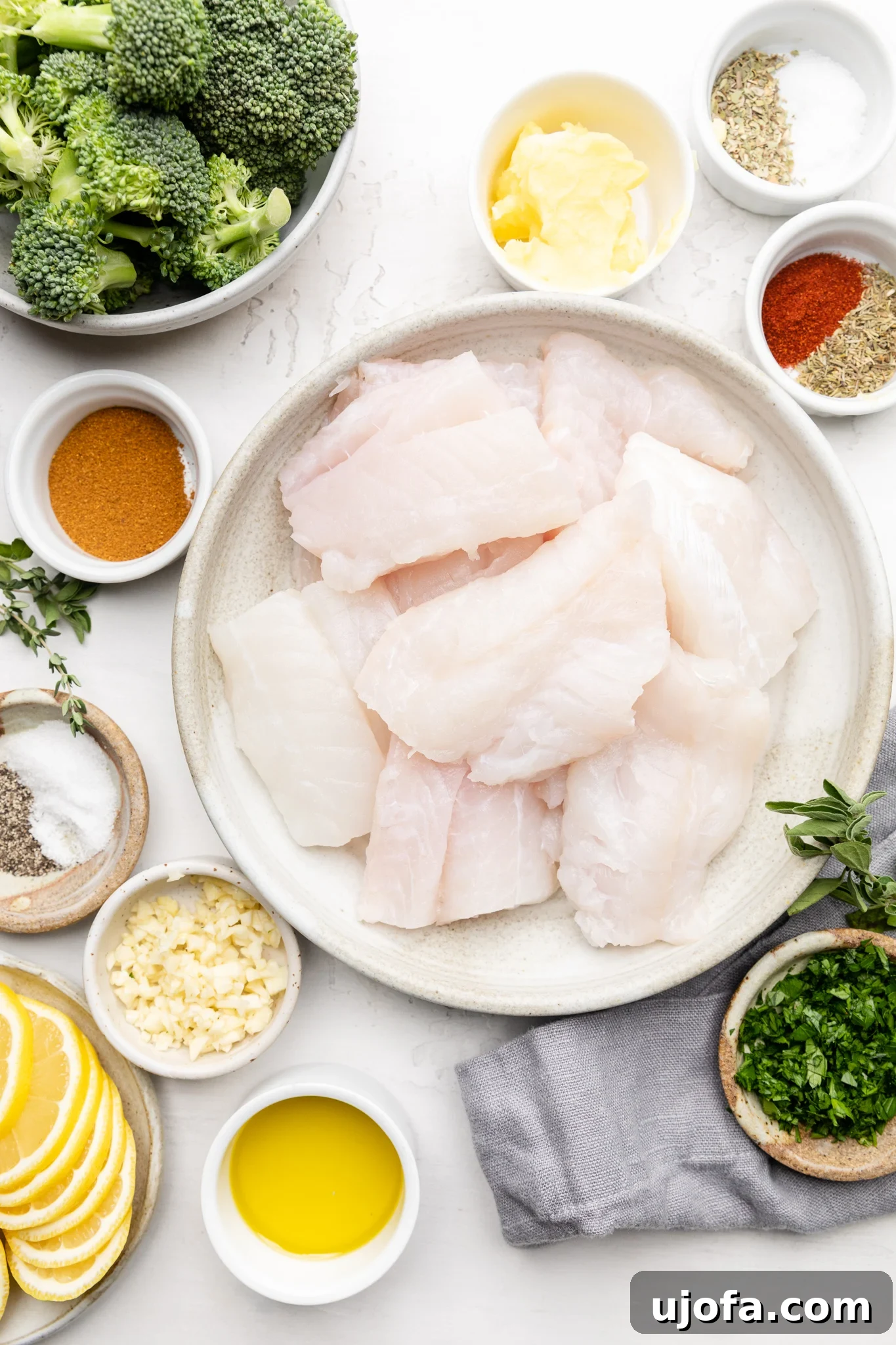 Ingredients for making Cajun butter sauce and cod and broccoli meal laid out on a table