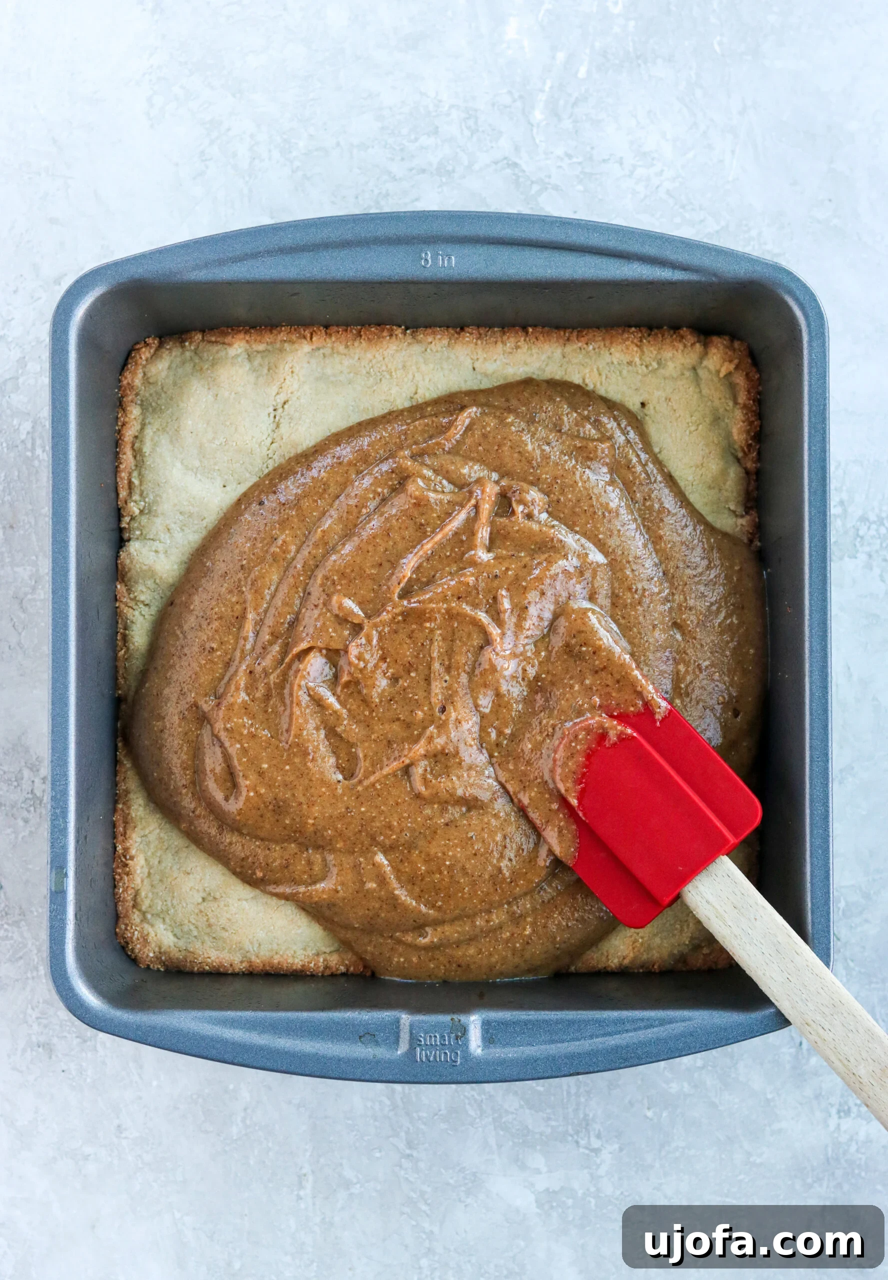 Baked gluten-free shortbread crust topped with an even layer of vegan peanut butter caramel.